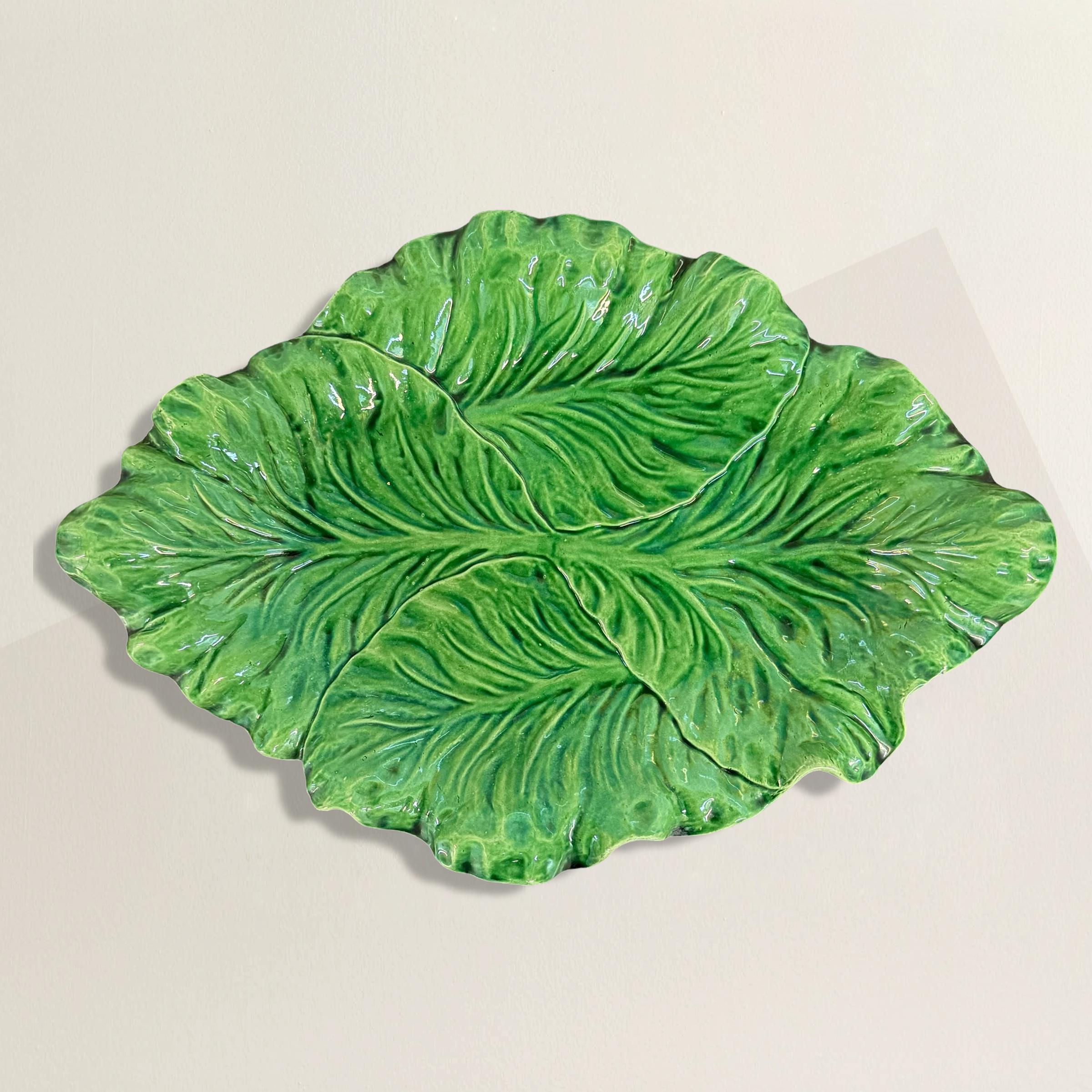This exquisite late 20th-century Portuguese ceramic cabbage platter, once a prized offering at the now-defunct but highly esteemed Bonwit Teller department store in New York City, stands as a testament to the store's legacy of luxury and elegance.