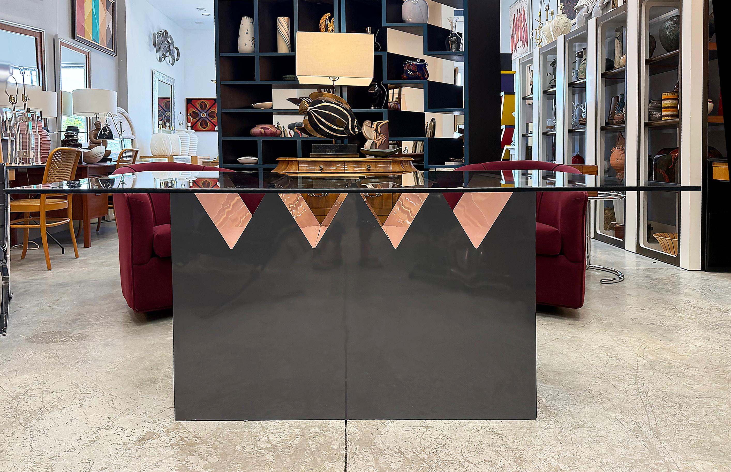 Late 20th Century Post Modern Memphis Style Dining Table

Offered for sale is a rare vintage Memphis Style dining table with a glass top. This sculptural piece has great color contrast within the design.  The base is gray and pink laminate over wood