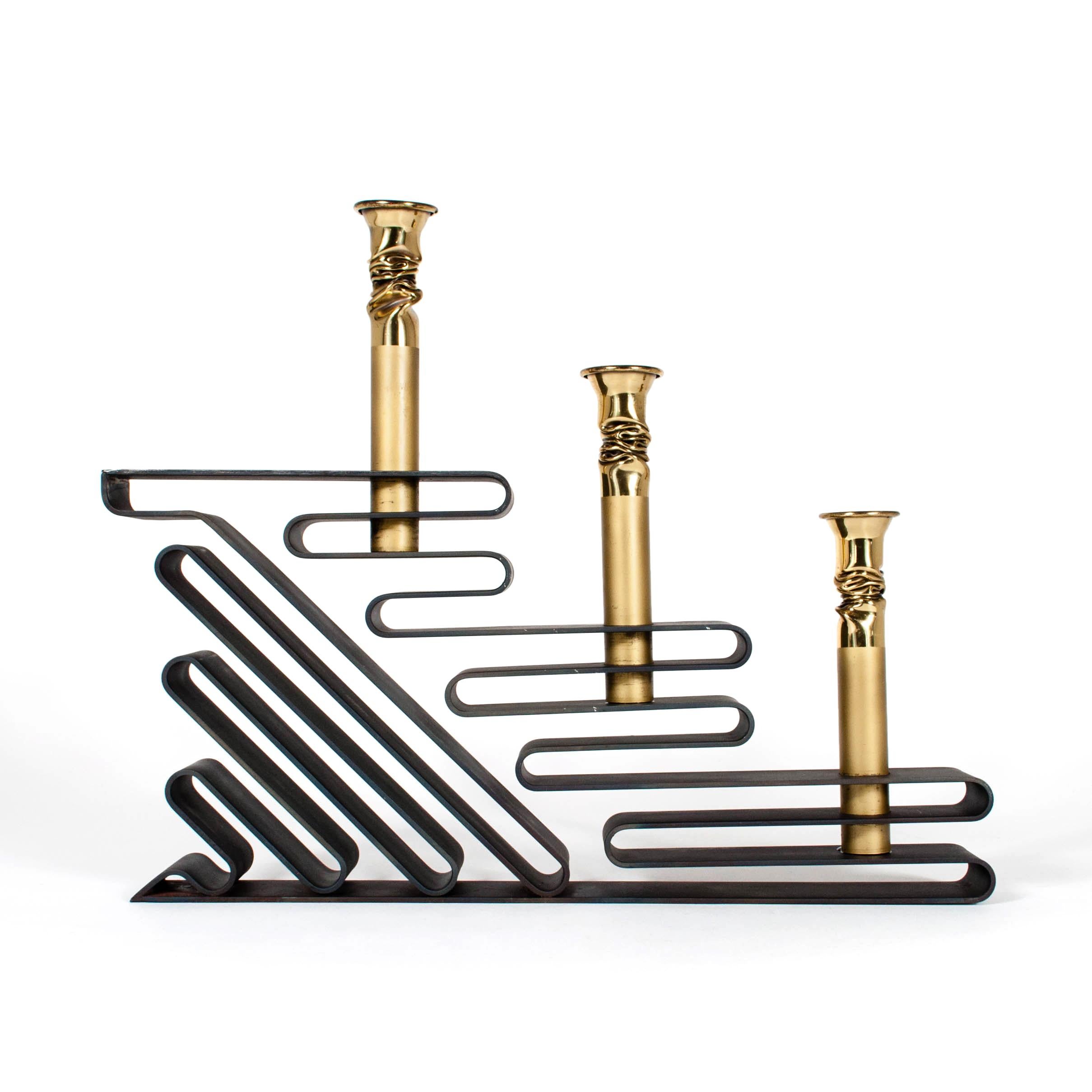 Distinctive black metal Postmodern candelabra with folded ribbon design and removable brass inserts. The piece is well made and heavy.
 