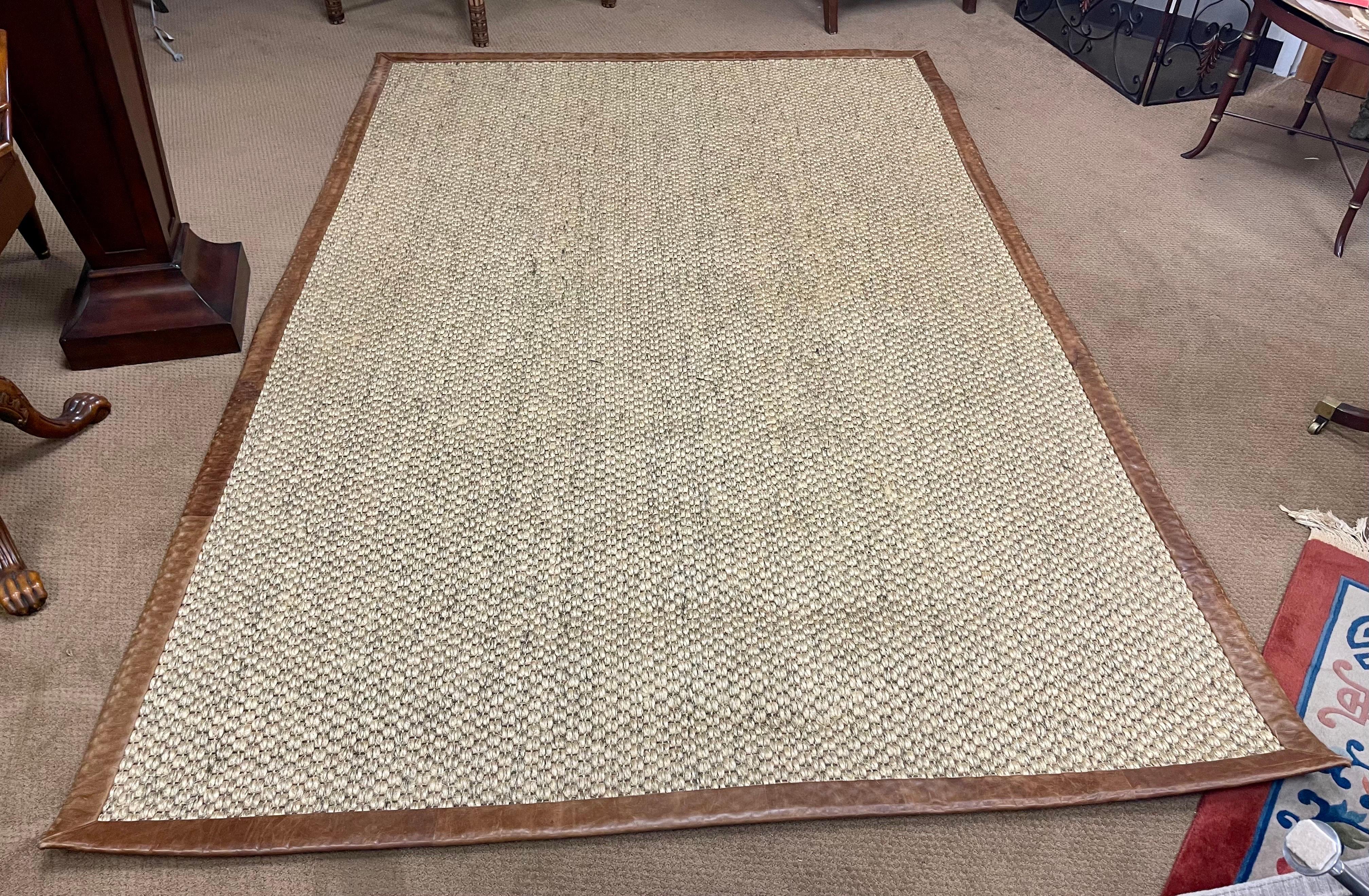 Exceptional late 20th century sisal rug from Ralph Lauren Home. The rug is rectangular and measures six feet by nine feet and has thick sisal bordered by the highest quality saddle leather. The border of leather measures 2.25