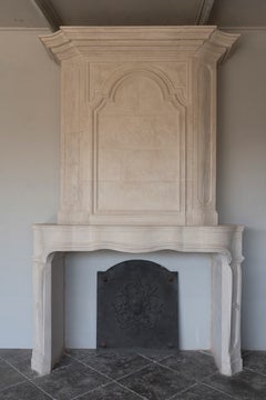 Late 20th century Re-edition Louis XIV style fireplace aged limestone