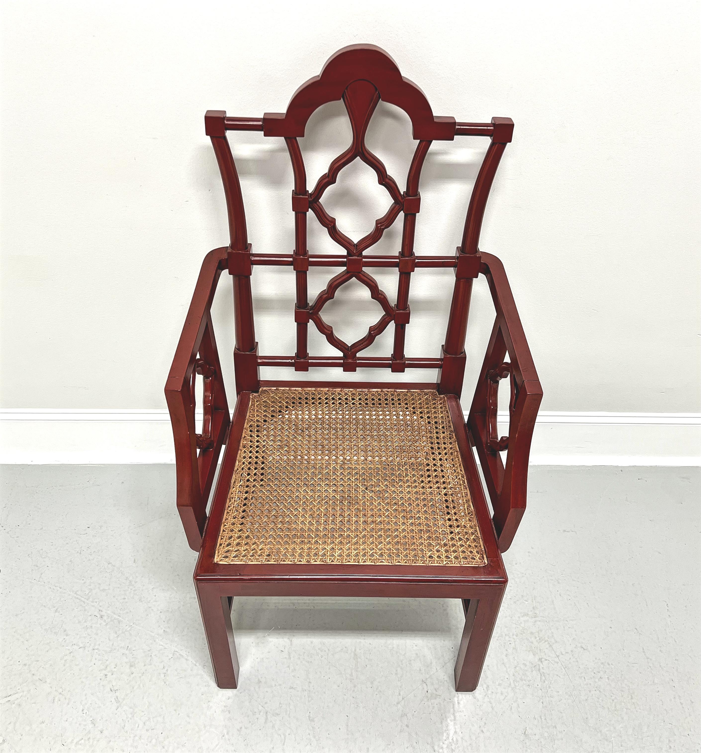 An Asian Chinese Chippendale style armchair, unbranded. Solid wood frame with red lacquer, high back, arched crest rail, decorative back rest with look of bamboo, square arms with decorative lattice, woven caned seat, fluted edge to stretchers, and
