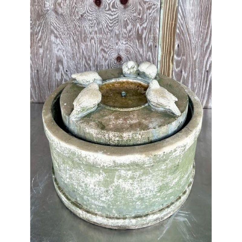 Create a haven of tranquility and classic charm in your garden or patio with this delightful vintage cast concrete bird fountain. Featuring charmingly sculpted birds perched around a central basin, this piece embodies timeless garden elegance. Its