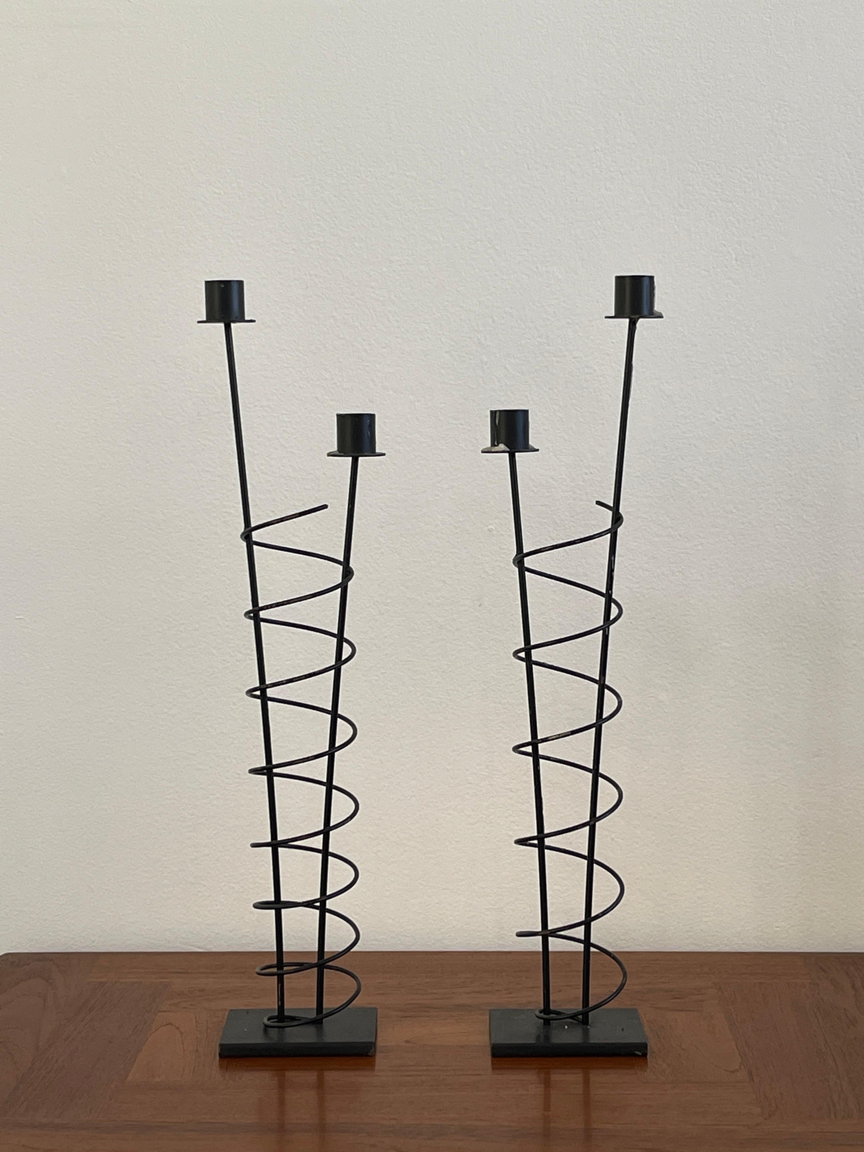 Late 20th Century Rick Martin Metal candlestick holders from the post modern time period. Martin produced amazing Memphis Design Sculptures, Clocks, Candle Holders and Wall Sculptures.

This set is wrought iron and the composition is spirals on