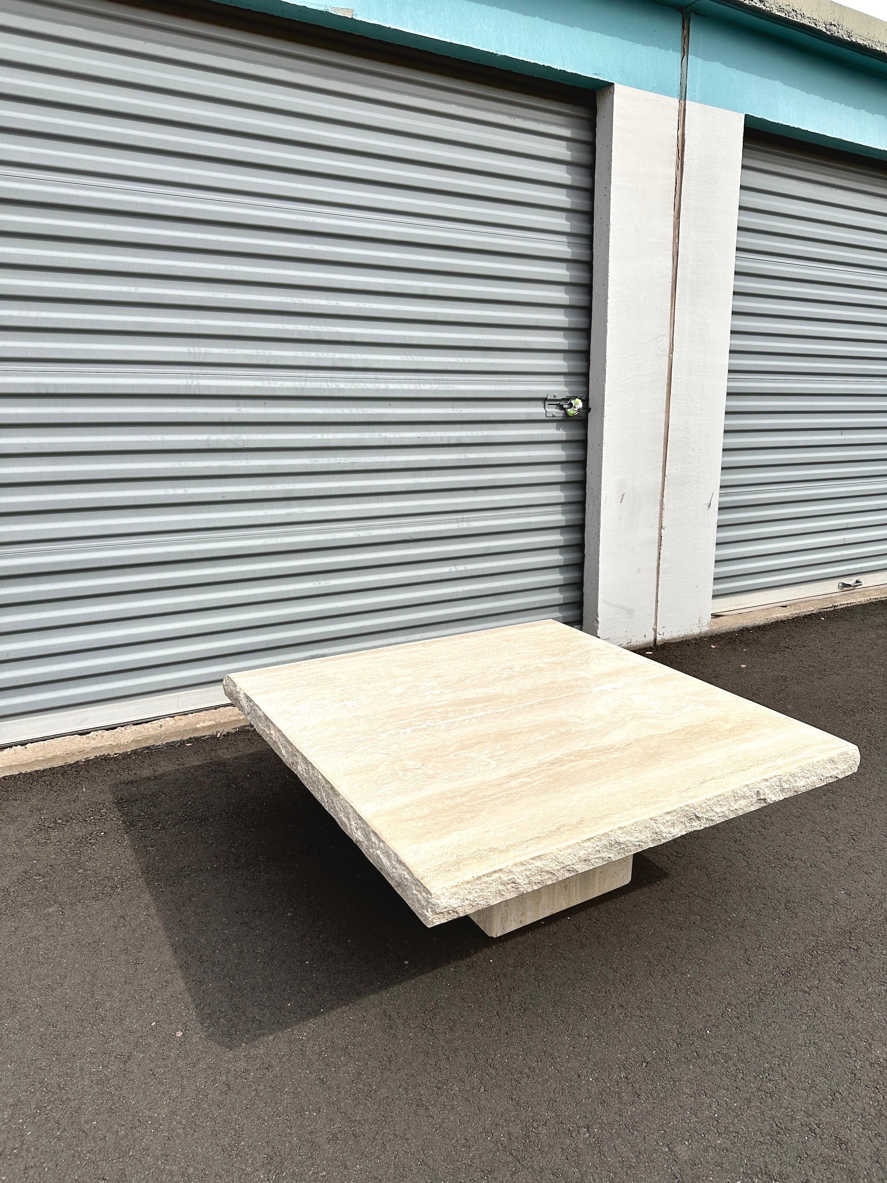 Sculptural and grounded, this square travertine coffee table celebrates the natural elegance of stone in its rawest form. The honed surface contrasts with a rough, uncut edge, striking a balance between refinement and organic texture.

Carved from