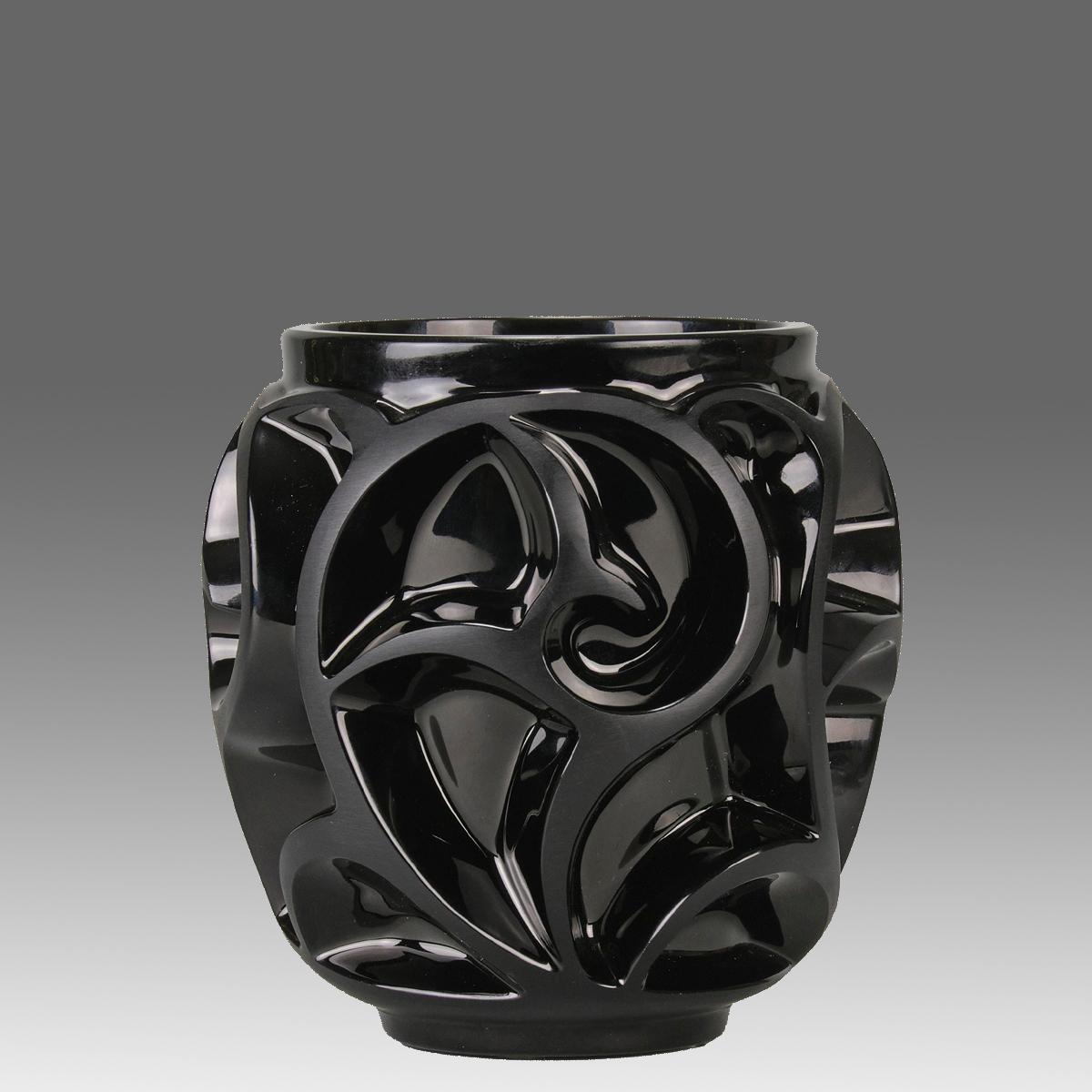 A dramatic black glass vase decorated with striking satin finished enamel swirls against a polished background, signed Lalique France.

ADDITIONAL INFORMATION
Height:                                       12.5 cm

Width:                             