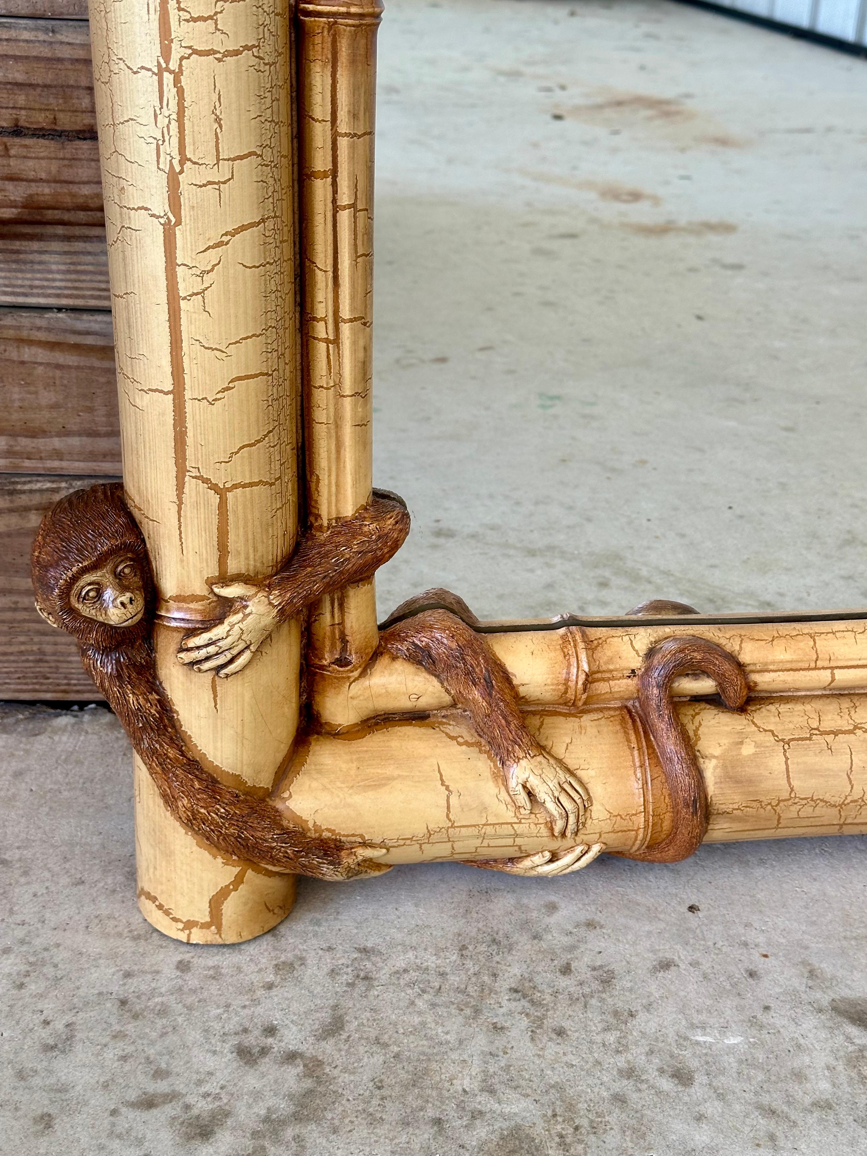 This adorably fun and whimsical faux bamboo composite sculptural monkey wall mirror is ready to hang and sure to bring a smile to your face. Each corner of the mirror features a playful sculptural monkey, adding a unique and lively touch to your