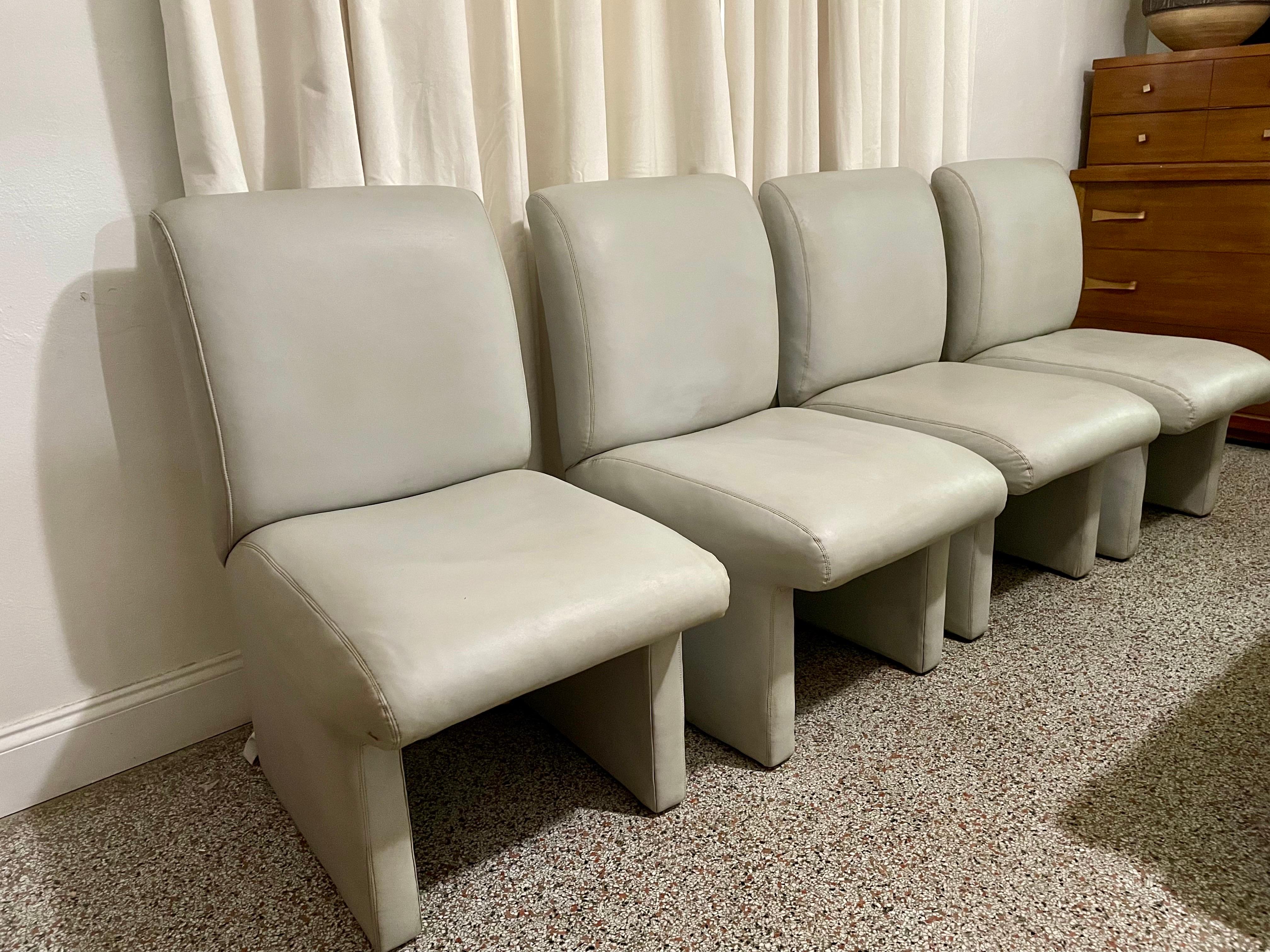 Set of 4 Postmodern Saporiti Italia Style Gray Leather Dining Chairs. Original upholstery in good vintage condition. Seat gracefully curves over legs to create a floating illusion. Perfect size for large dining or conference table