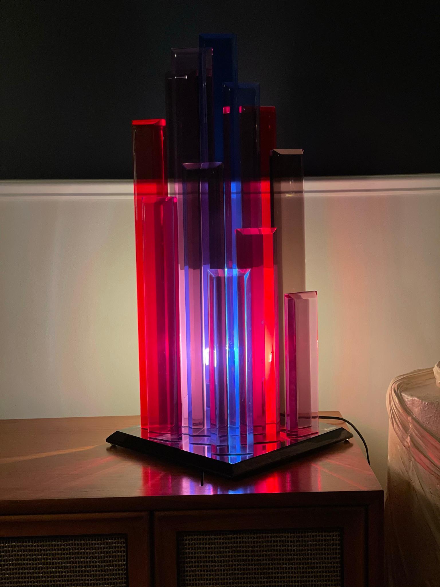 Stunning Multi-Color Lamp by Shlomi Haziza. Unique design as only Haziza can create. Beveled Acrylic towering varied heights to cast wonderful color. Modern Cityscape design. Red, Blue, Purple.
