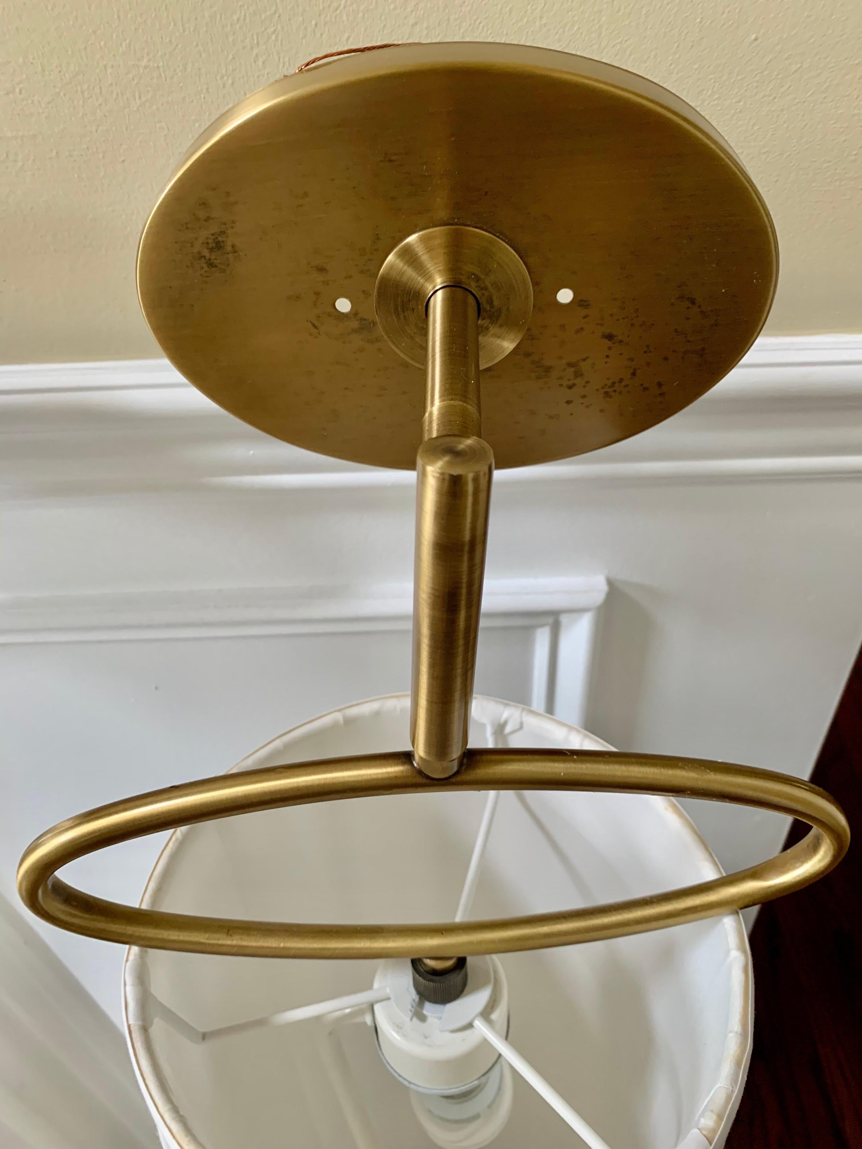 Pair of exquisite vintage large brass wall sconces. Tall with pleated creamy white shades which are in excellent condition. No stains, tears or marks on the shades. They are supported by sturdy metal frames which are not visible from inside the