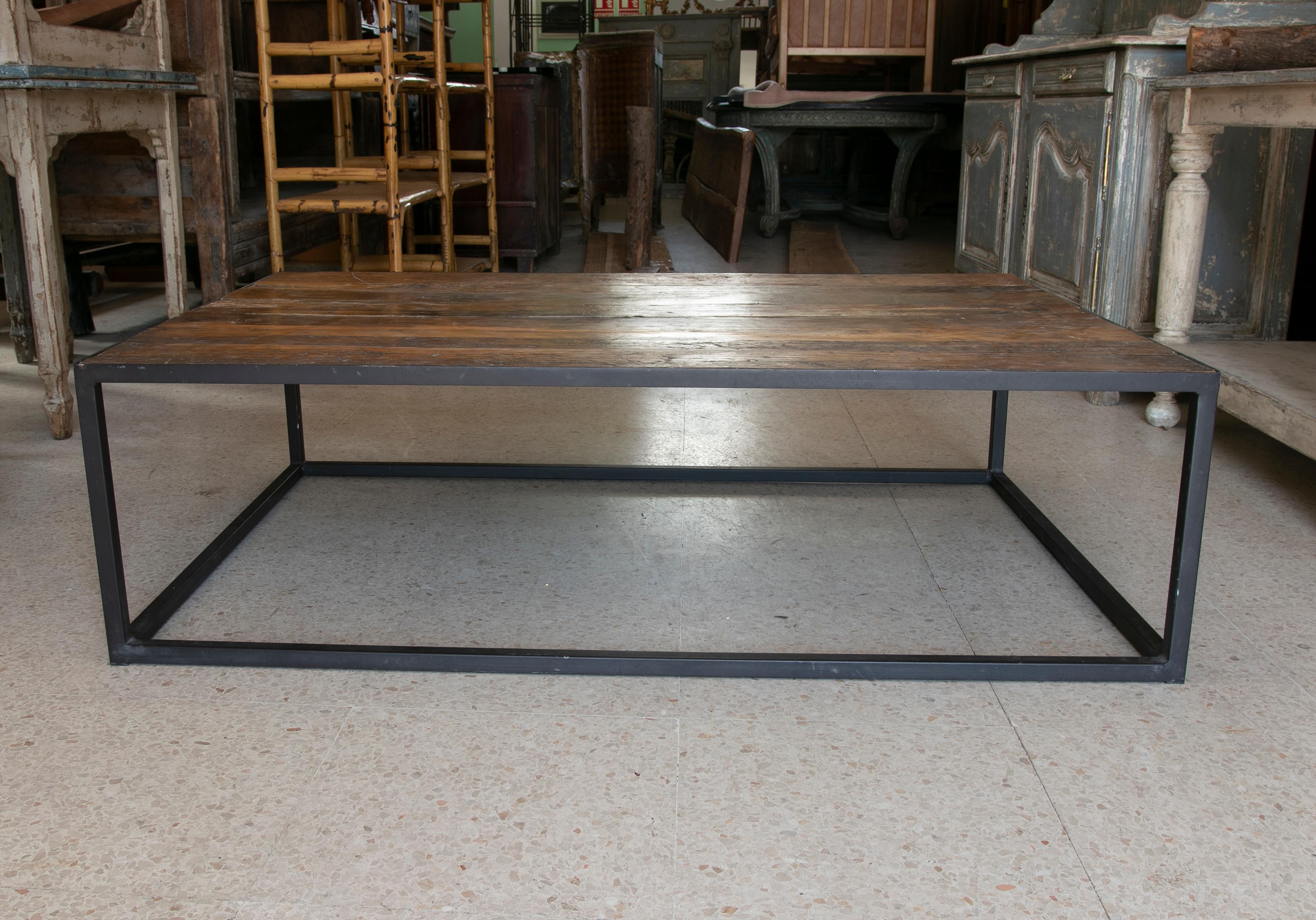 Rustic 1990s Spanish iron cube coffee table with distressed wood top.
    