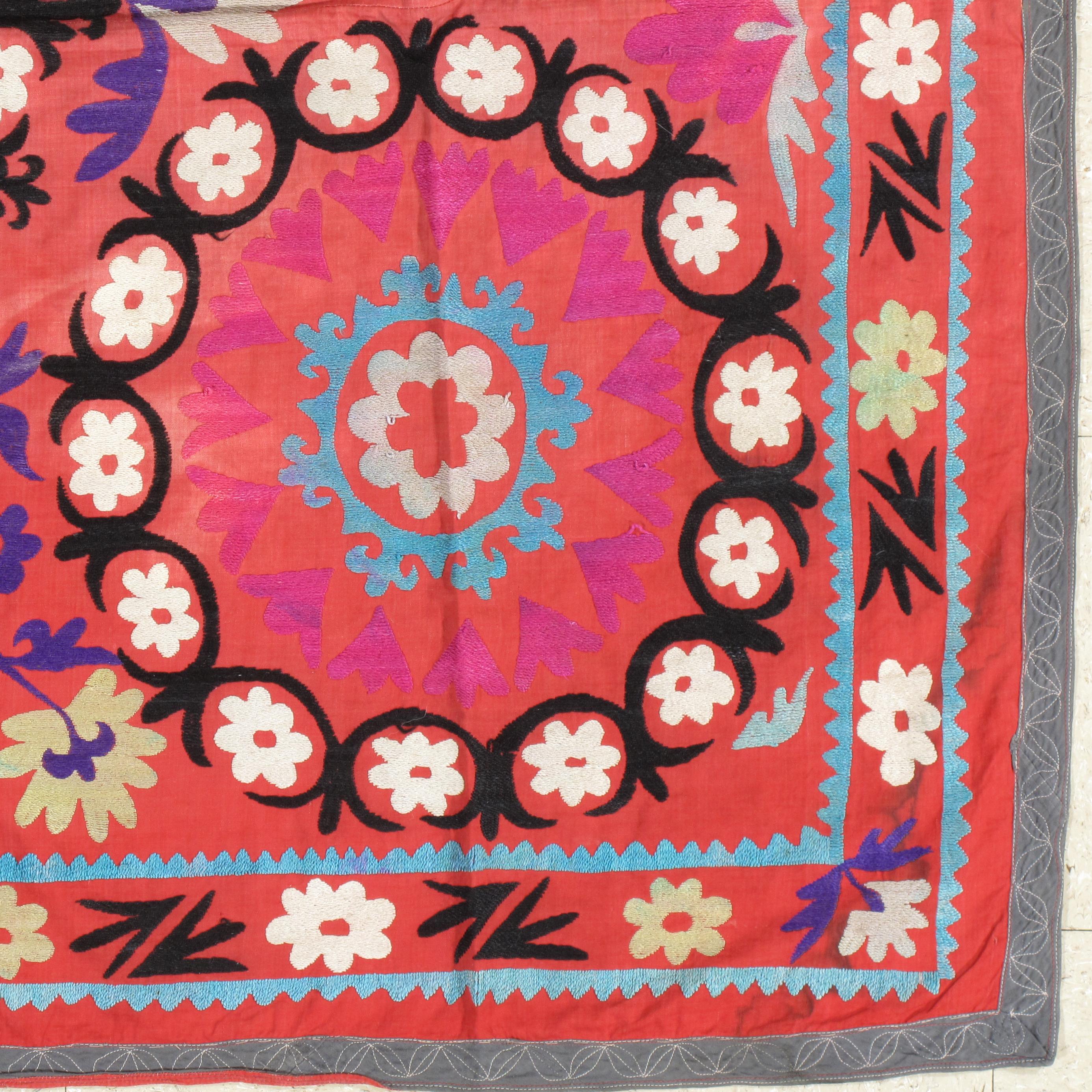Finely woven cotton-ground Vintage Suzani with hand-embroidery. Fine floral design. This Suzani embroidery has the most noticeable, soporific color pallet. Very fine, 20th century Suzani textile. With vibrant pink silk highlights. 

Measures: 4'6