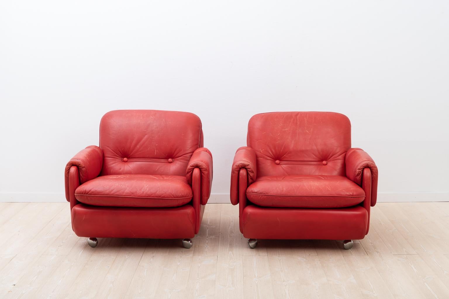 Lombardia red leather armchairs designed by Risto Holme for IKEA. Manufactured during the 20th century in Sweden. Caster wheels in chrome. The seats have some minor wear and loss of color.