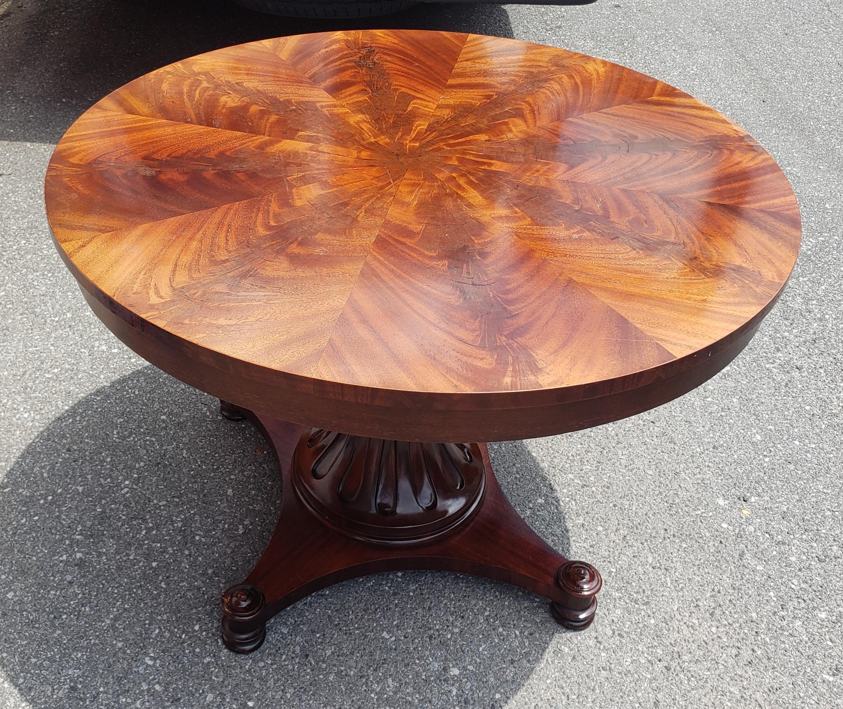 A beautiful late 20th Century Swirl medium finish mahogany with quadpod reeled pedestal. Flamed bookmatched top. Measures 44