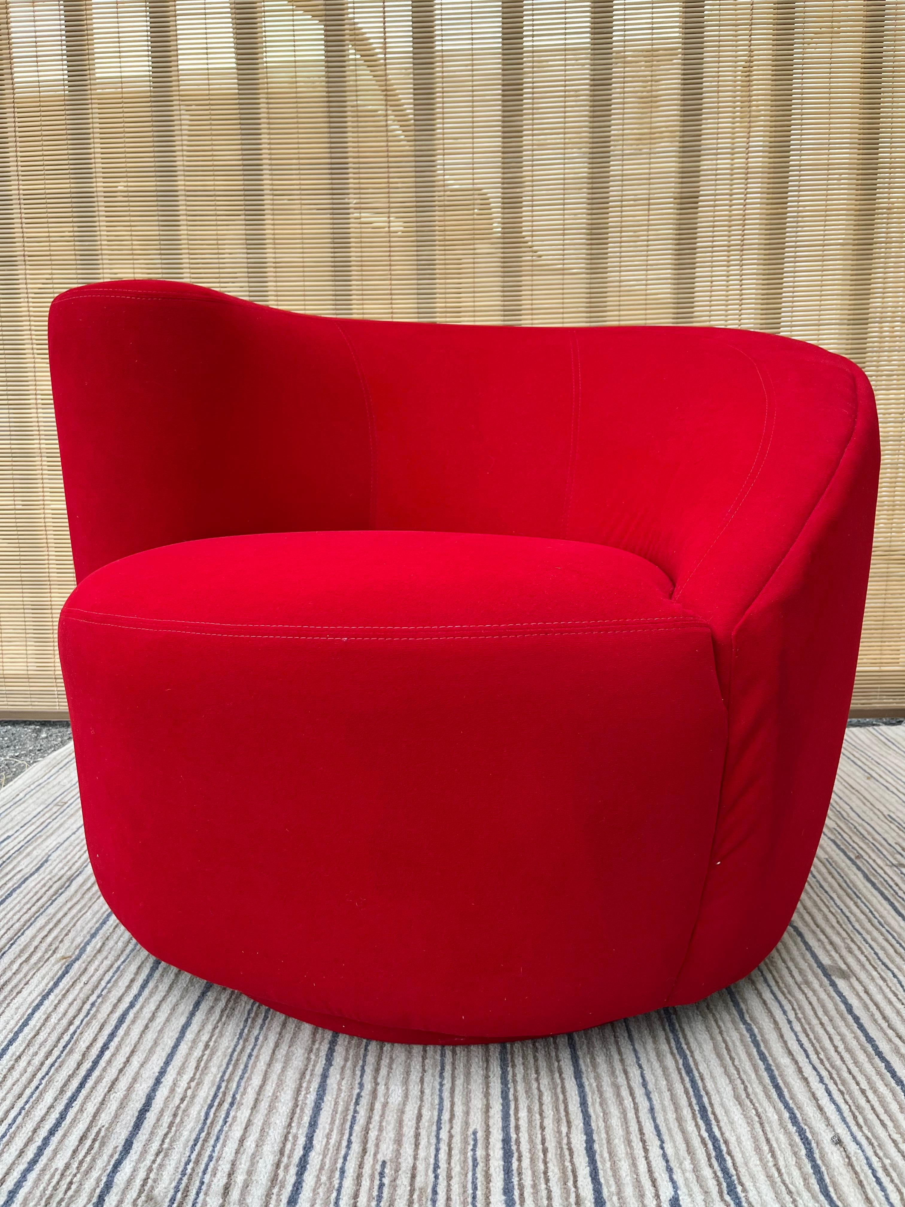 Late 20th century Post Modern upholstered Swivel lounge chair. Circa 1990s.
Features a futuristic asymmetrical design with the original red ultra-suede upholstery. 
In excellent original condition with minor signs of wear consistent with age and