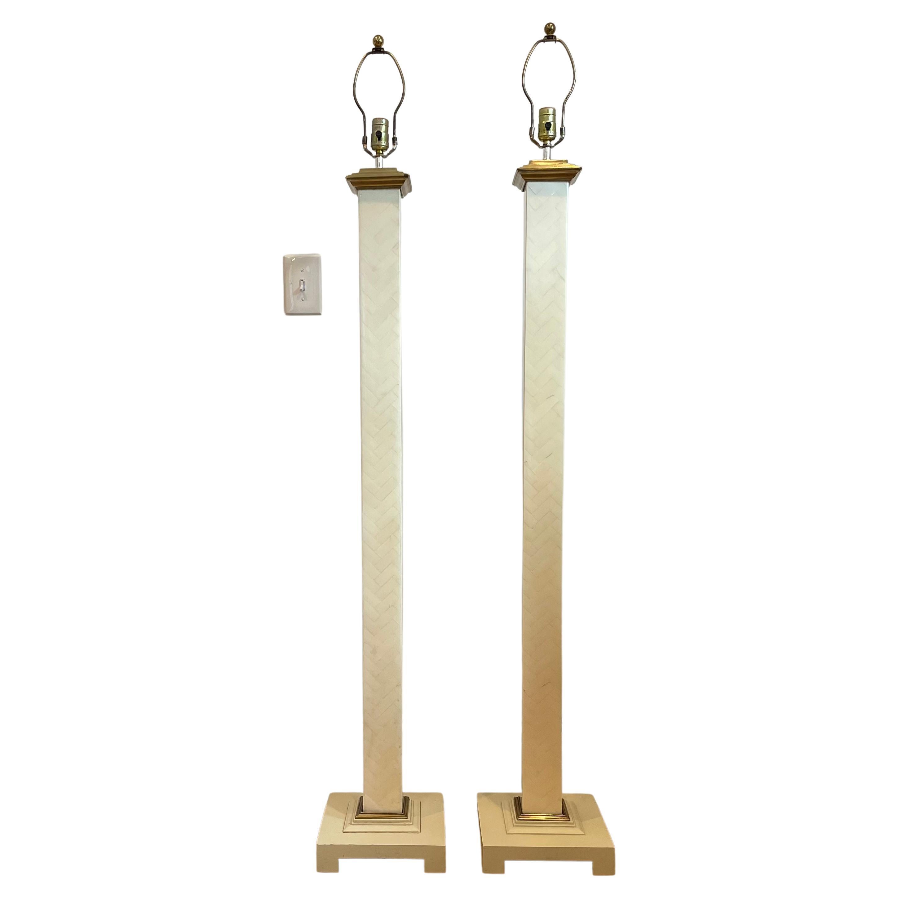 Herringbone pattern Tessellated floor lamps with brass accents in the manner of Enrique Garcel.
Lamp to socket is 54.5”.