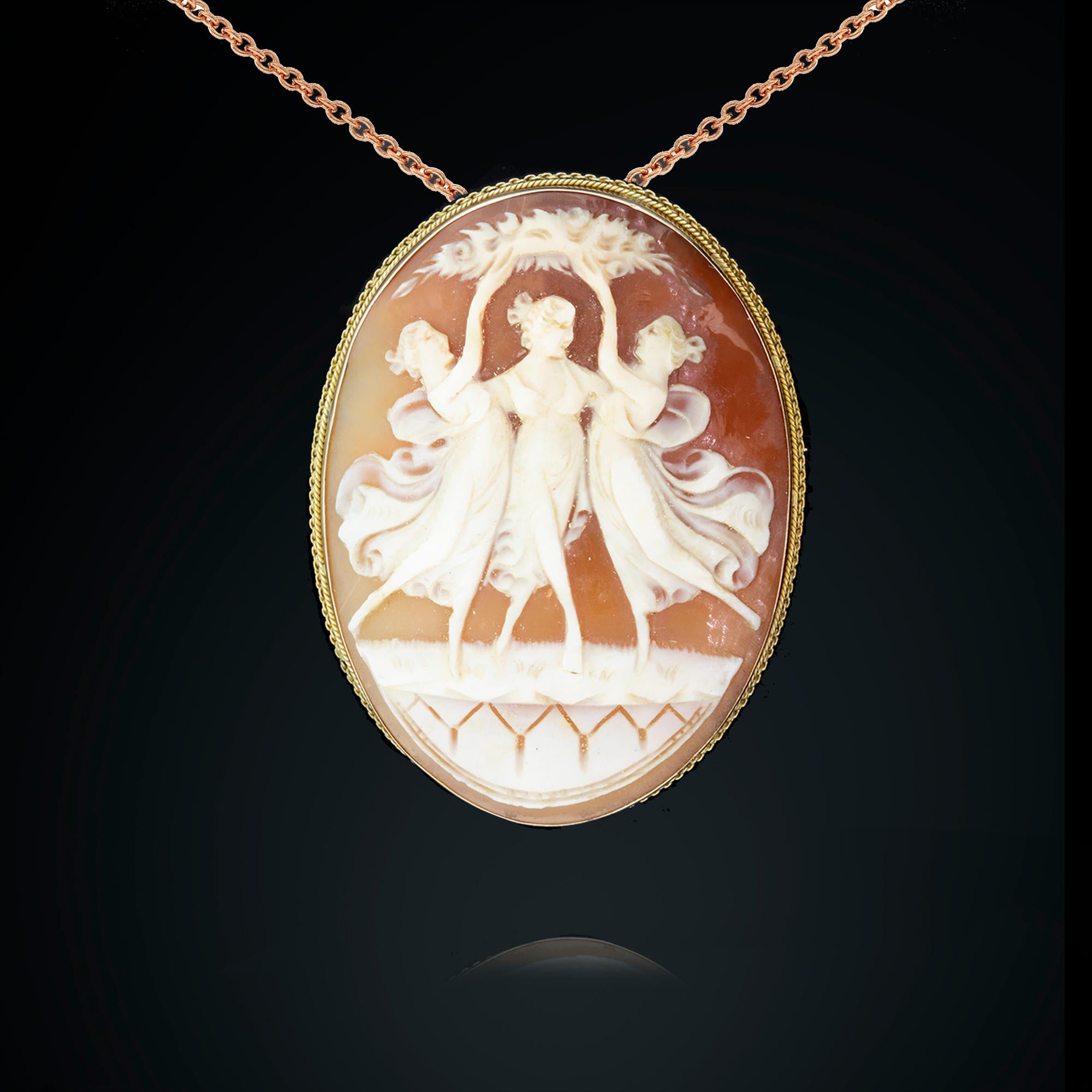 One 18k yellow gold hand carved shell cameo depicting the antique Greek theme of the “Three Muses”. Gold pin, roller catch, and collapsible pendant runner.

Metal: 18k yellow gold
Weight: 15.13 grams
Measurements: Length 5cm, width 3.7cm
Era: Late