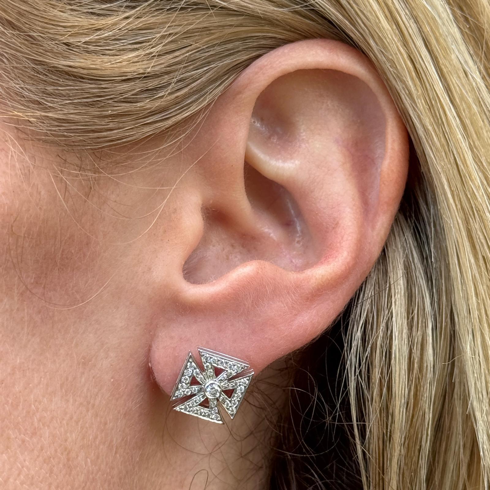 These elegant Tiffany & Co. earrings feature the iconic Maltese Cross design, crafted in platinum and set with sparkling diamonds. Measuring approximately 11 x 11 mm, the earrings are secured with la pousette backs for comfort and reliability. The