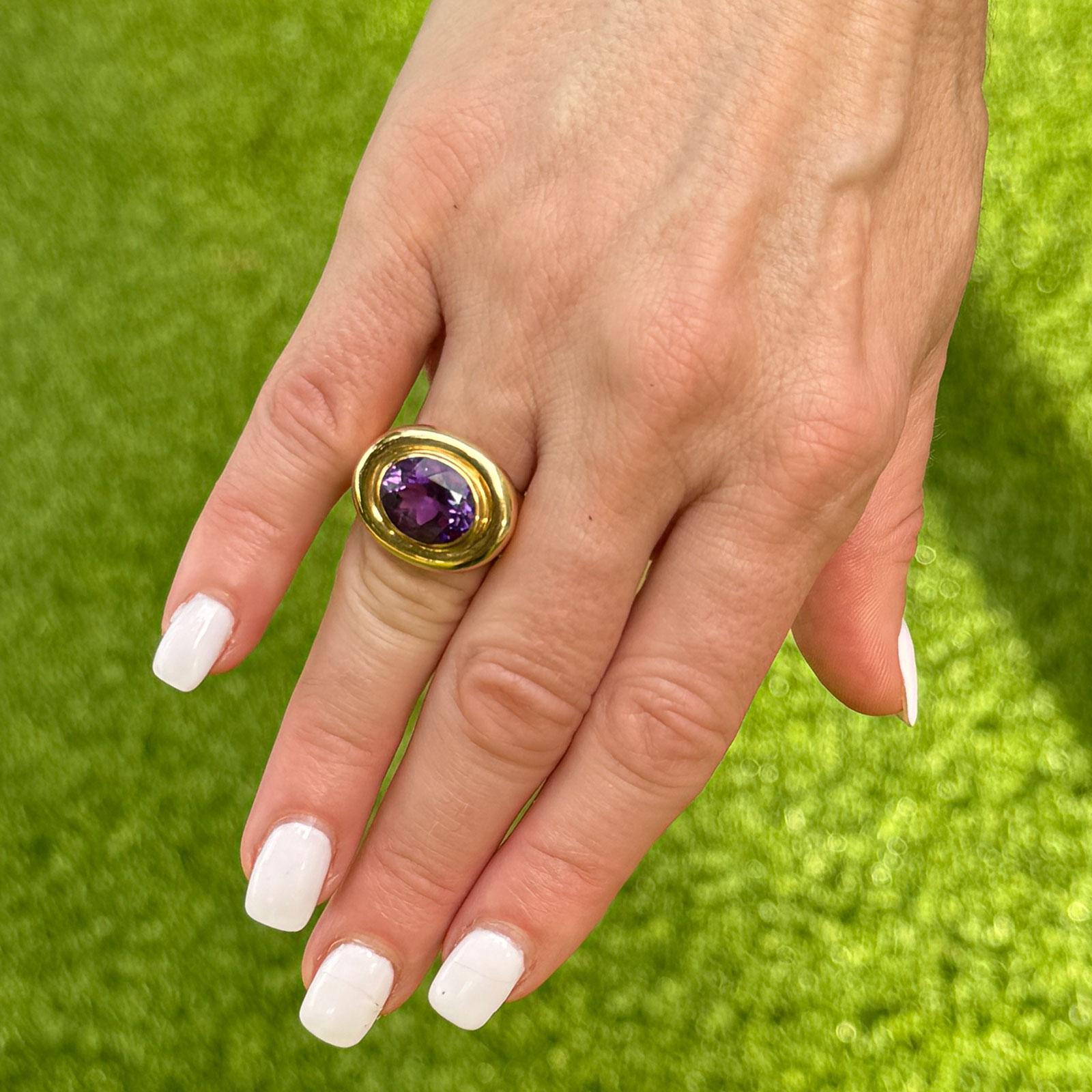This striking 1980s Tiffany & Company ring, designed by Paloma Picasso, features a captivating bezel-set oval amethyst that showcases the rich, deep purple hues characteristic of this beautiful gemstone. The top of the ring measures 17 x 21mm,