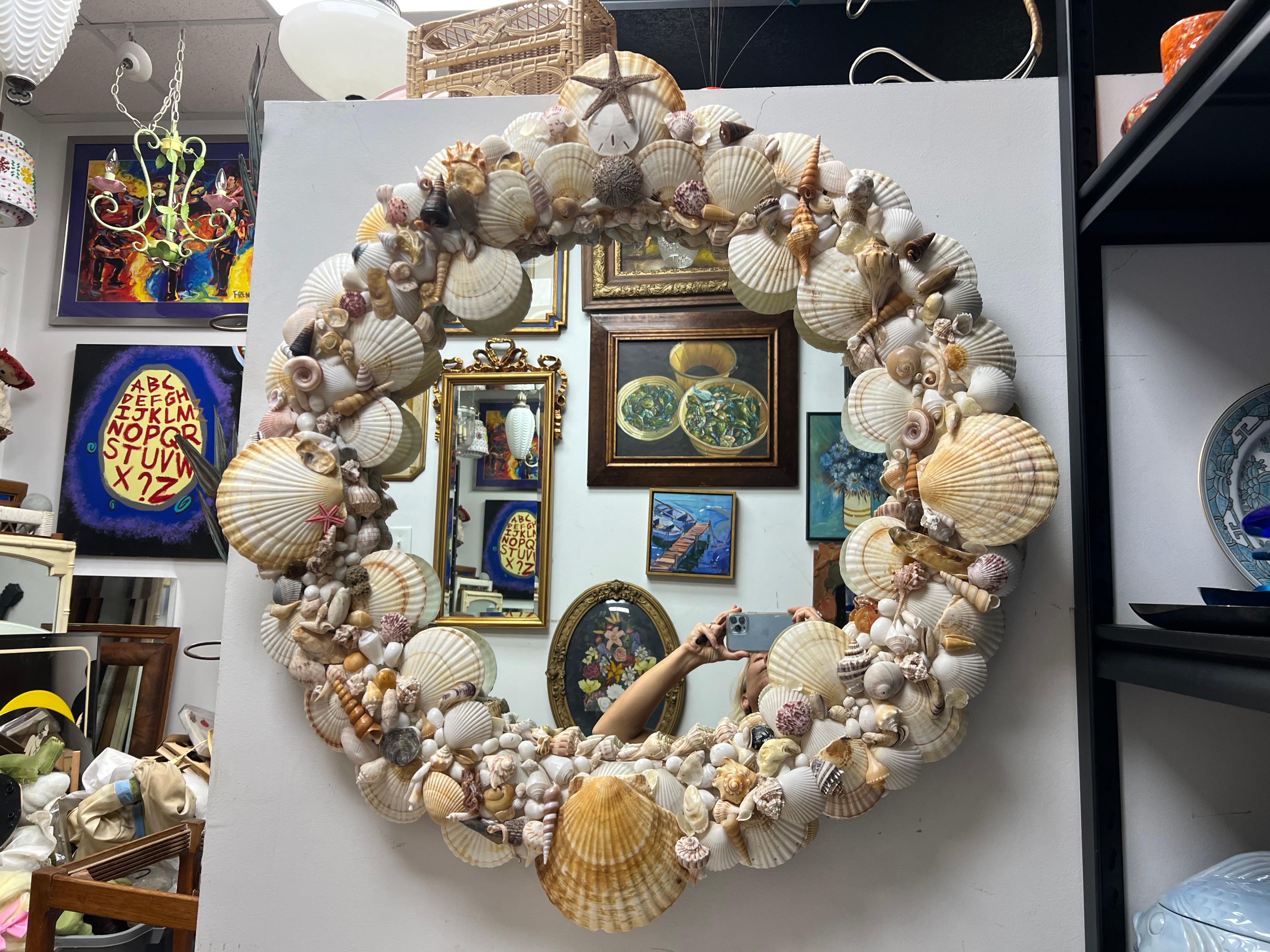 This piece was created by a local charleston  artisan and will make the perfect addition to your home with its seashell encrusted frame in natural, earth-tone colors.
