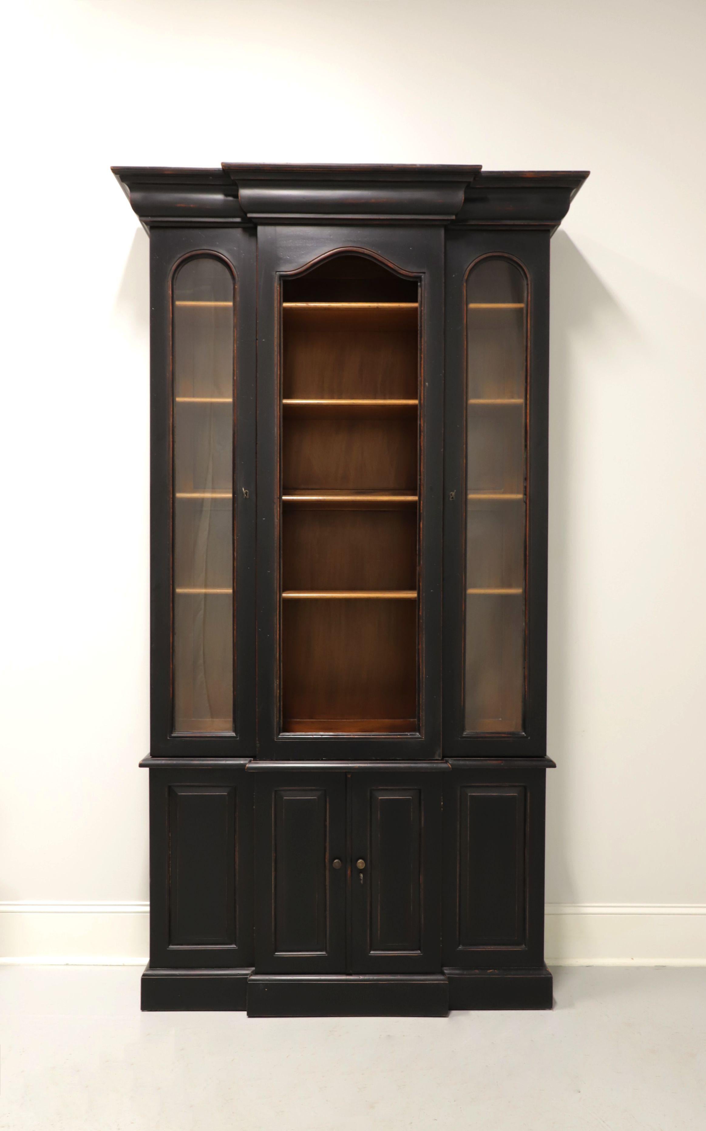 A Traditional style breakfront bookcase, unbranded. Hardwood with a distressed black finish, breakfront, crown molding to top and metal hardware. Upper cabinet features a center framed arched open area with four adjustable wood shelves; flanked by