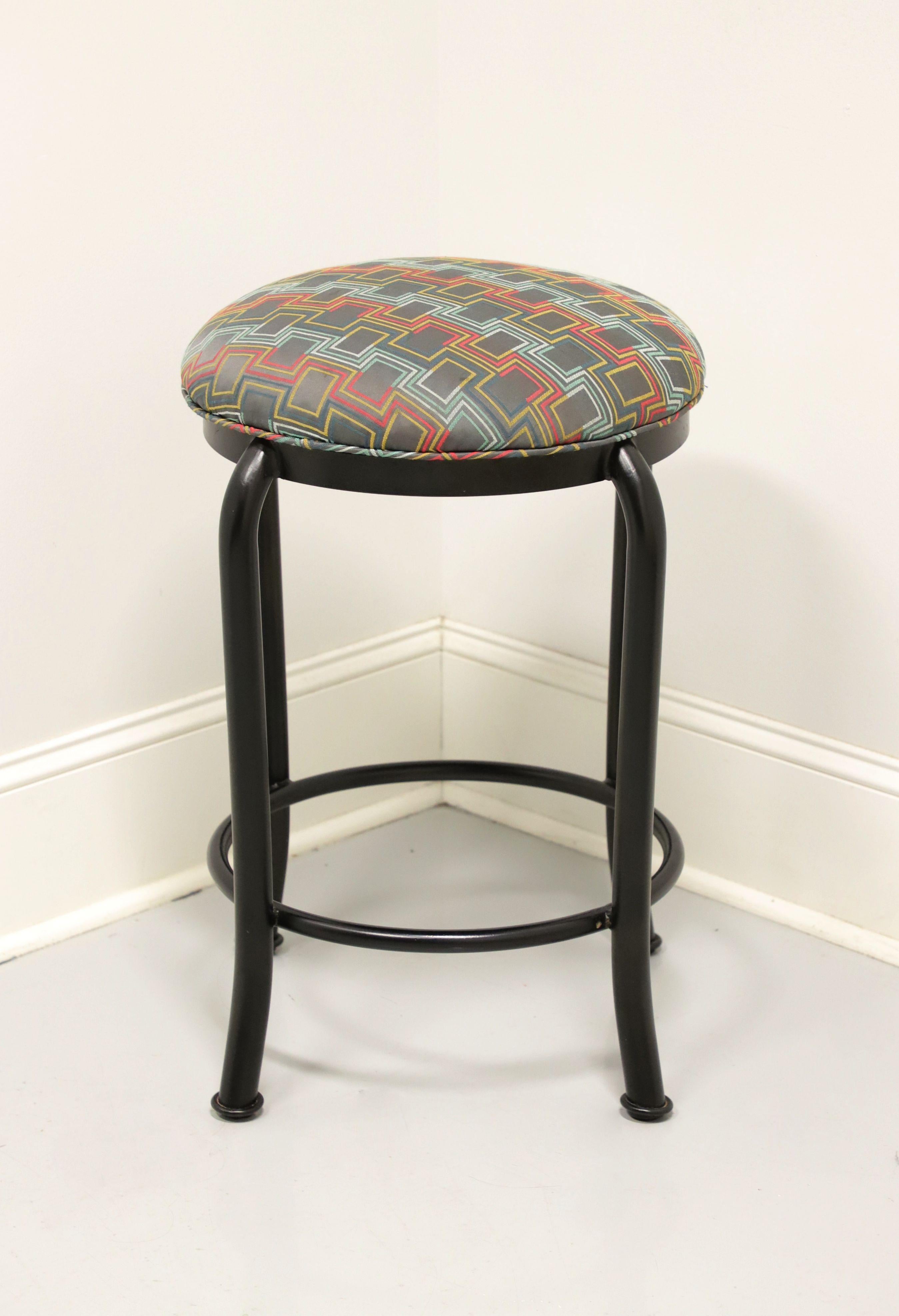 A Transitional style counter-height stool, unbranded. Black metal frame, 360 degree swivel mechanism, geometric pattern fabric upholstered seat and metal surround footrest. Likely made in the USA, in the late 20th Century. 

Measures: Overall: 17w