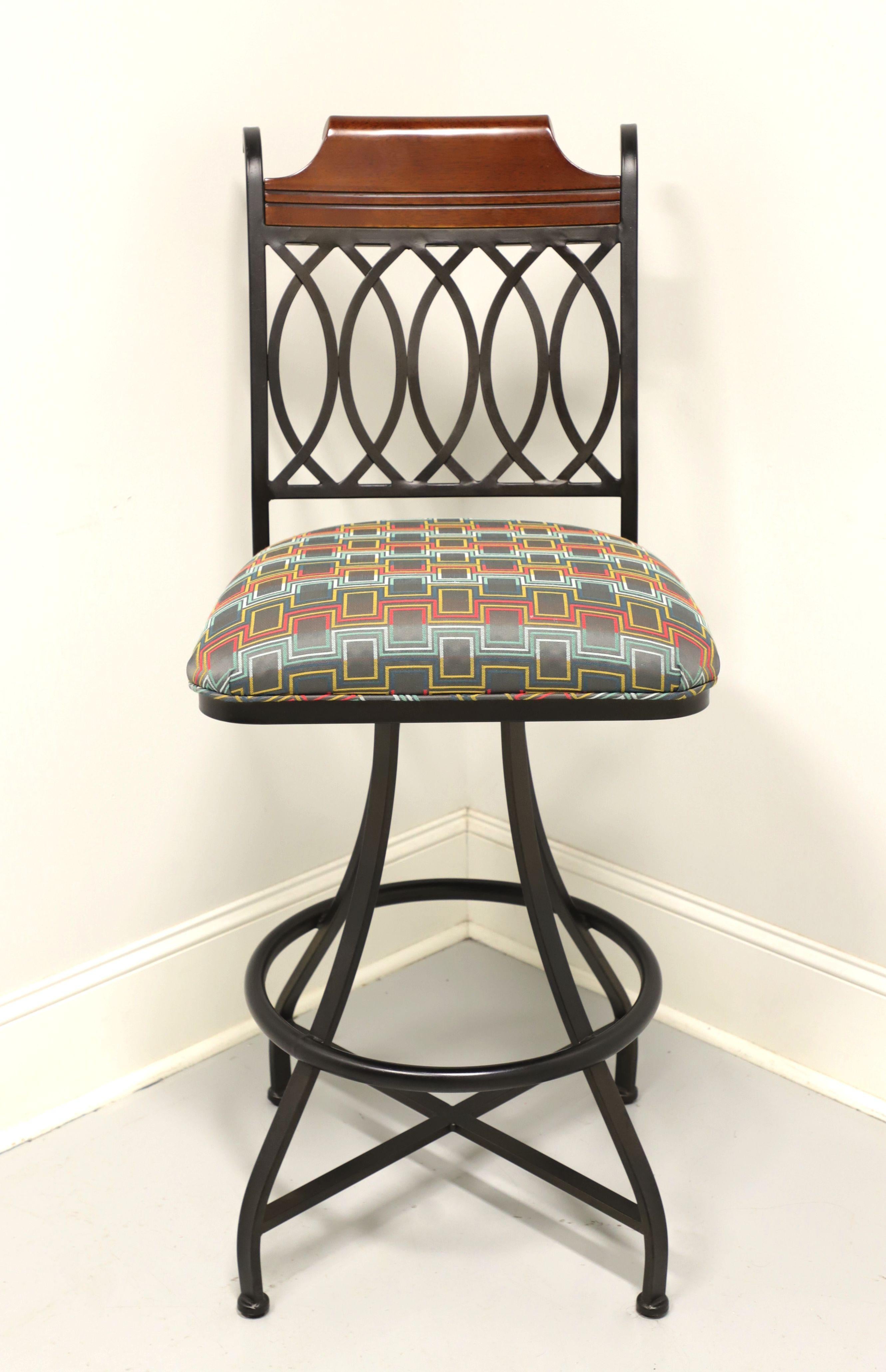 A Transitional style bar-height barstool, unbranded. Black metal frame, decorative wood crestrail, open weave metal backrest, 360 degree swivel mechanism, geometric pattern fabric upholstered seat and metal surround footrest. Likely made in the USA,