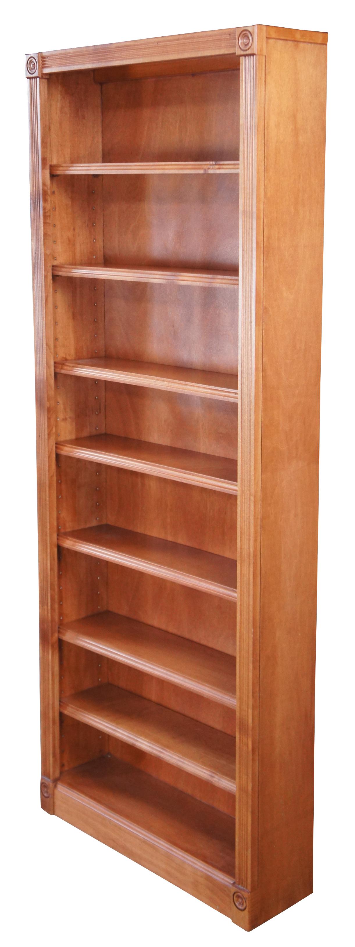 A vintage bookcase in Victorian manner. Tall and slender, finished in pine. Features seven adjustable shelves, fluted stiles and circular medallions. Measures: 60