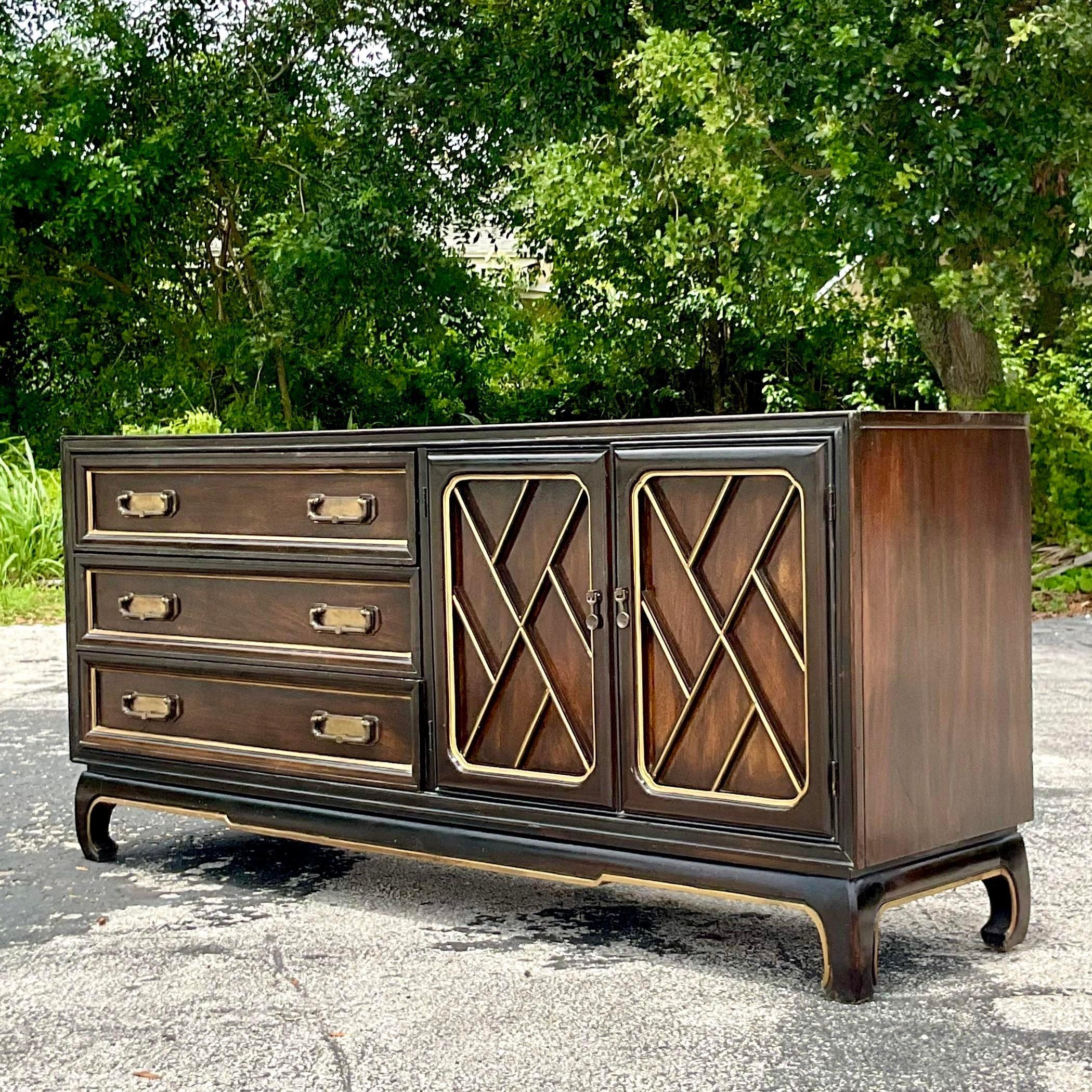 A fabulous vintage Boho credenza. Made by the iconic American of Martinsville. Beautiful Chinese Chippendale door fronts with a chic Ming plinth. Gilt touches along the trim. Acquired from a Palm Beach estate. 