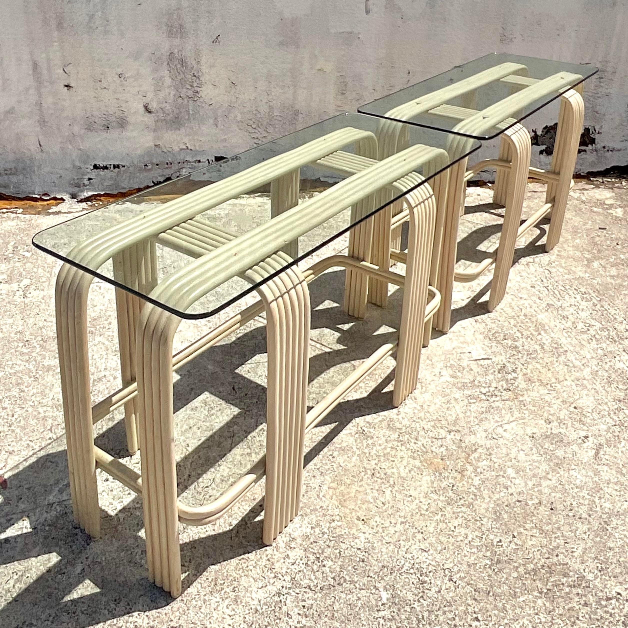 Elevate your home décor with this captivating pair of Vintage Boho Bent Rattan Console Tables, showcasing quintessential American style. Crafted with meticulous detail and infused with bohemian charm, these tables exude a timeless elegance that
