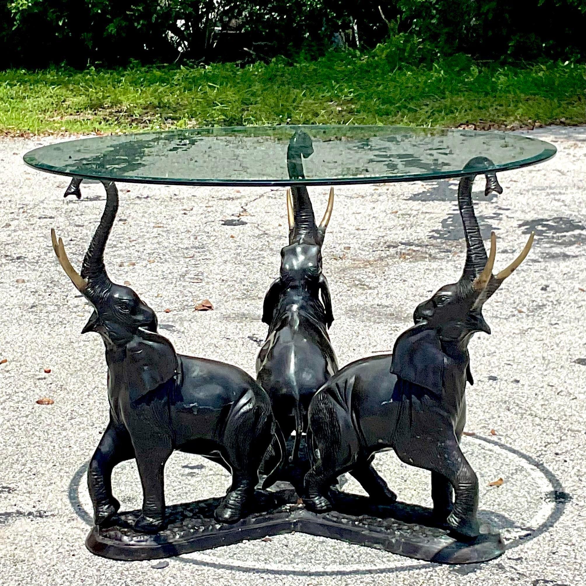 A striking vintage Boho dining table. A trio of bronze elephants with chic brass tusks. Perfect as a dining table or even a beautiful entry hall table. You decide! Acquired from a Palm Beach estate