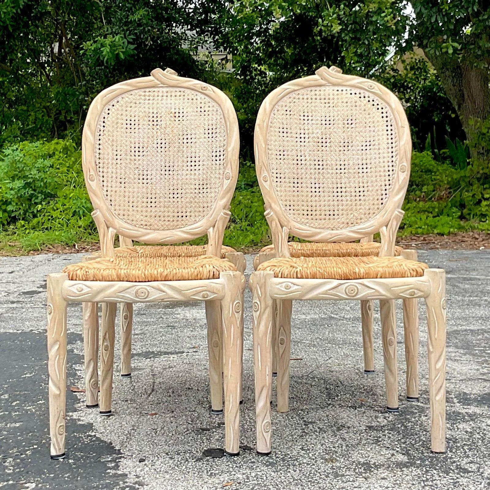 A fabulous set of 4 vintage Boho dining chairs. A chic hand carved Faux Bois design with a cerused finish. Beautiful rush seats are perfect as is or just add a cushion on top. You decide! Acquired from a Palm Beach estate.