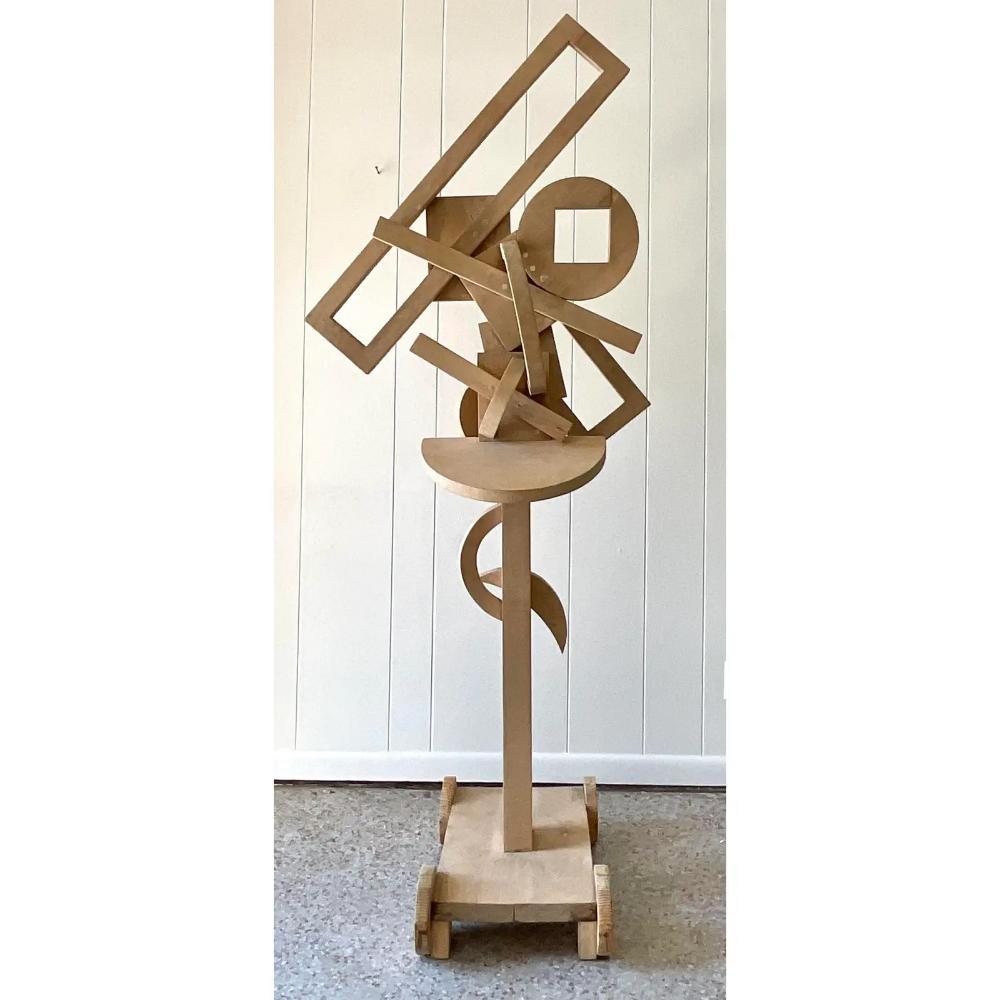 An incredible vintage Boho monumental floor sculpture. A tall and impressive composition in the constructivist style. An assemblage of wooden geometric shapes in a totem style. Acquired from a Palm Beach estate