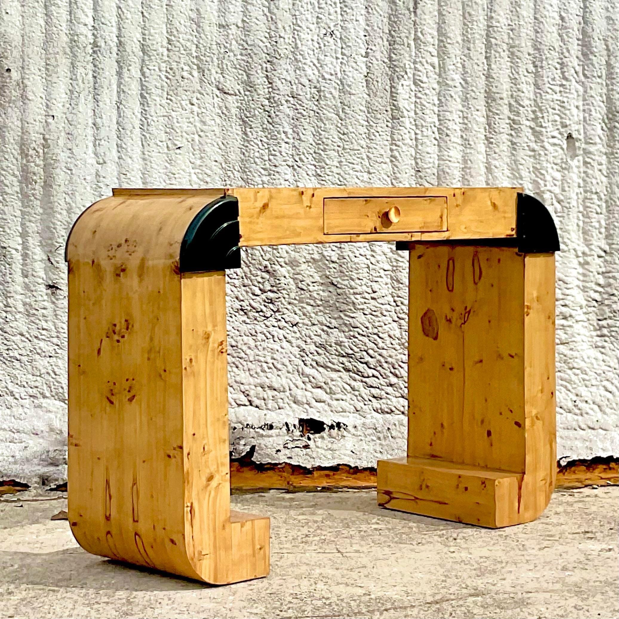 A fabulous vintage Deco console table. A chic waterfall shape in a Burl wood construction. Lacquered black corner detail. Two tables available on my page if a pair is needed. Acquired from a Palm Beach estate. 
