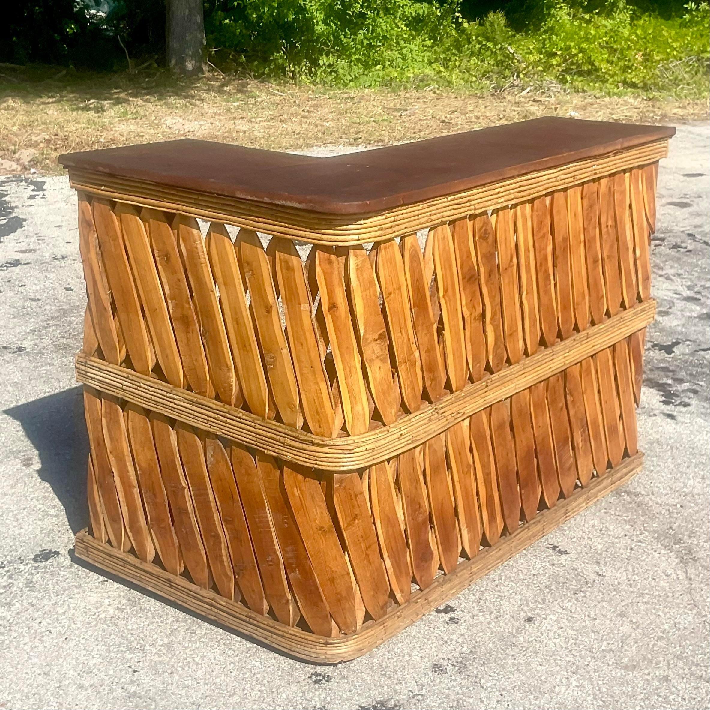 A fabulous vintage Boho Dry bar. The coveted Equipale style with cross hatched wood and bands of pencil reed. A chic pebbled leather top on an L shape. Acquired from a Palm Beach estate.