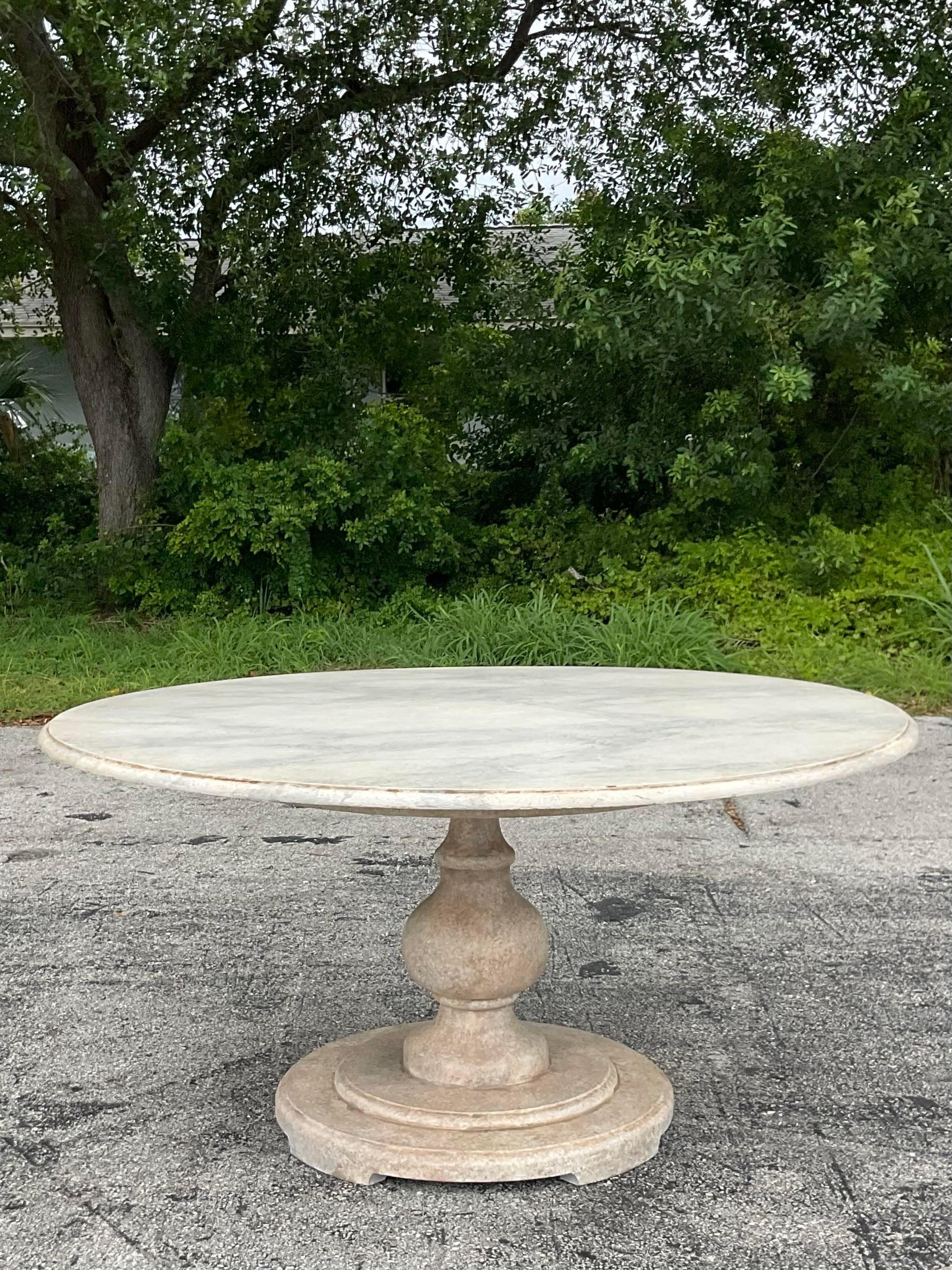 A spectacular vintage Boho dining table. A chic faux Finished marble done by hand. A turned wood pedestal base below. Acquired from a Palm Beach estate. 