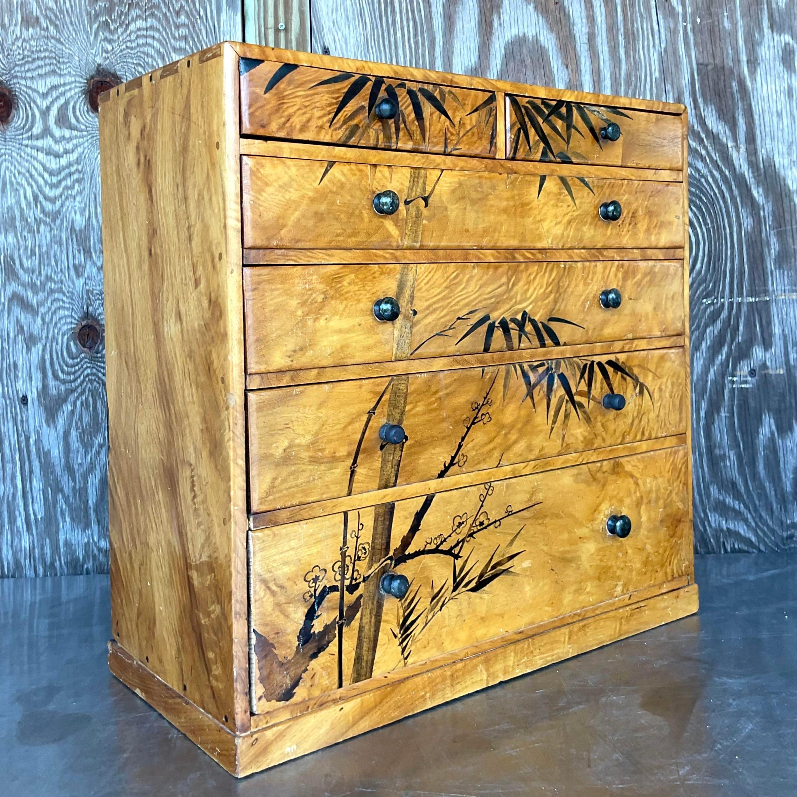 Elevate your décor with this captivating Vintage Boho Hand Painted Burl Wood Petite Chest of Drawers, merging artistic flair with American charm. Crafted with exquisite burl wood and adorned with hand-painted designs, this chest exudes Bohemian