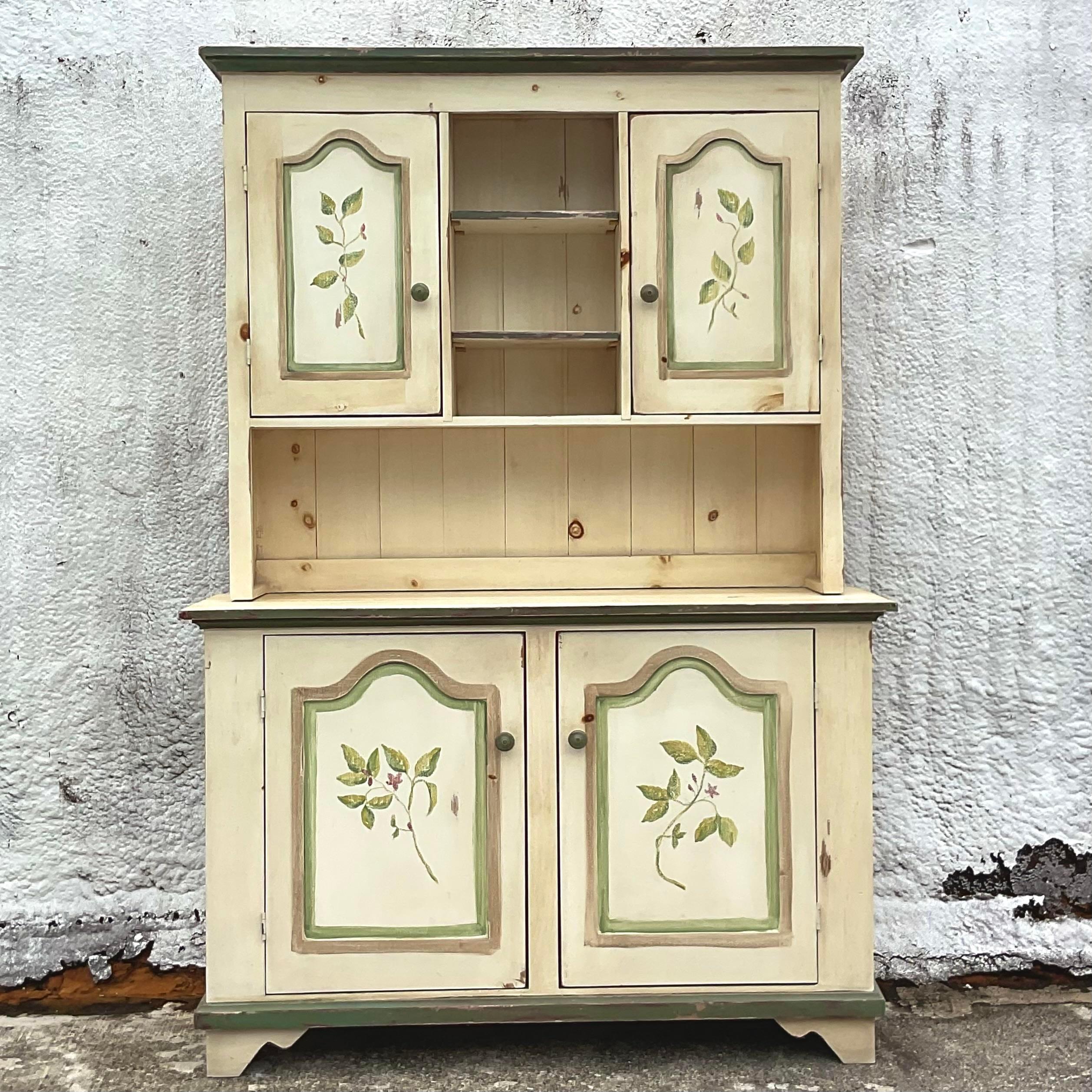 A fantastic vintage Boho China hutch. Beautiful hand painted detail in chic pale colors. Lots of great storage below and above. Acquired from a palm Beach estate.