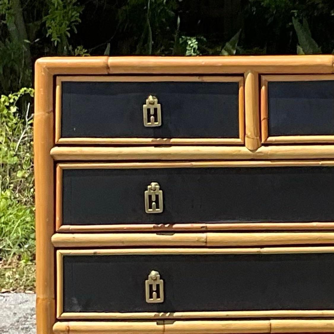 Elevate your storage solution with this vintage chest of drawers, featuring a Boho-inspired design with lacquered rattan trim. Infused with American craftsmanship, this piece adds a touch of eclectic charm to any space, blending functionality with