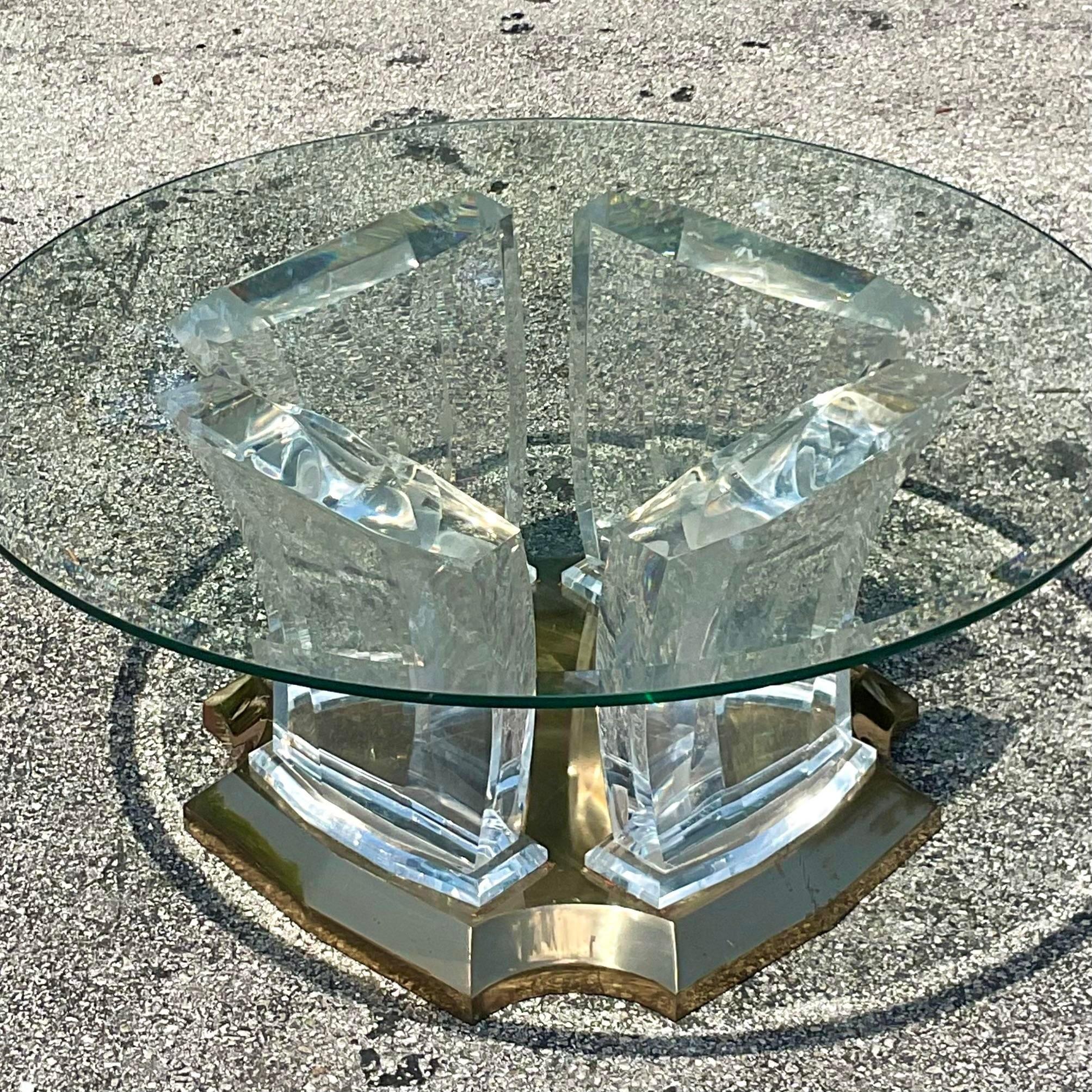 Embrace the timeless allure of American craftsmanship with our Vintage Boho Lucite and Brass Coffee Table. Infused with the eclectic spirit of Bohemian design and the enduring elegance of brass accents, this piece adds a touch of nostalgia and