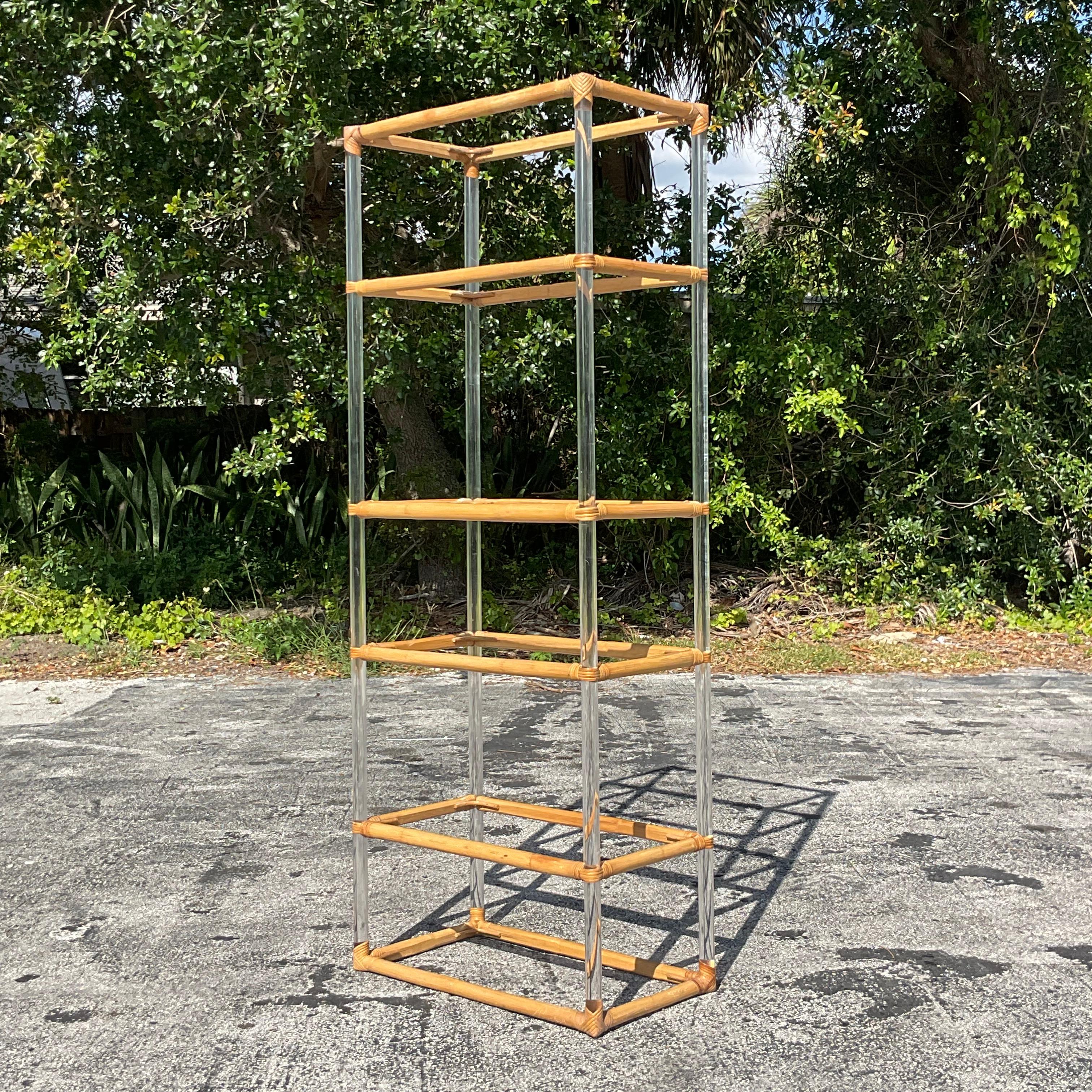 Infuse your space with eclectic charm using this vintage etagere featuring a combination of Lucite and rattan. With its bohemian flair and American craftsmanship, this piece adds a touch of whimsical elegance to any room, offering both style and