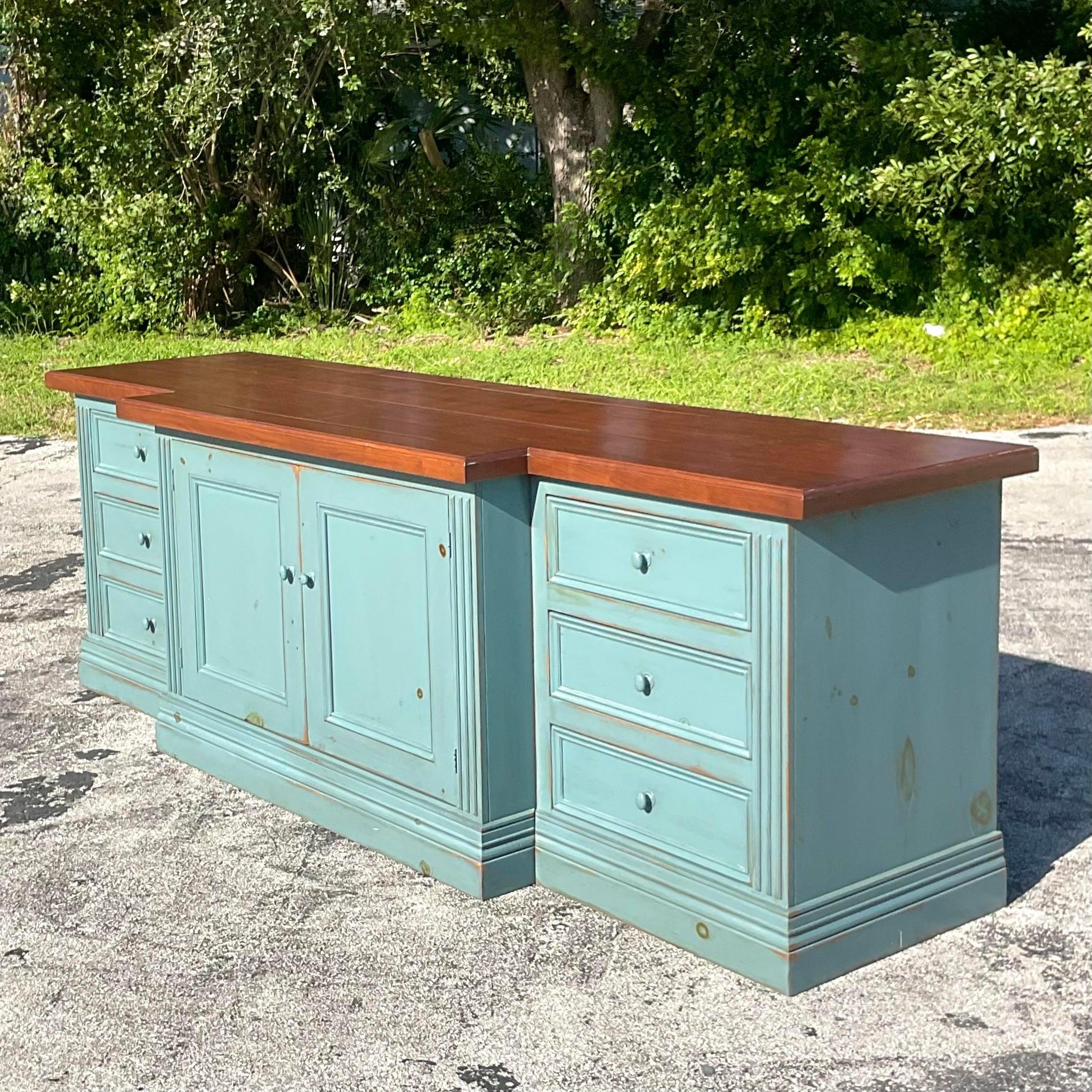 A fantastic vintage Boho long credenza. A chic matte blue wash cabinet with a natural wood top. Monumental in size and drama. Separates into three pieces for easy movement. Acquired from a Palm Beach estate.