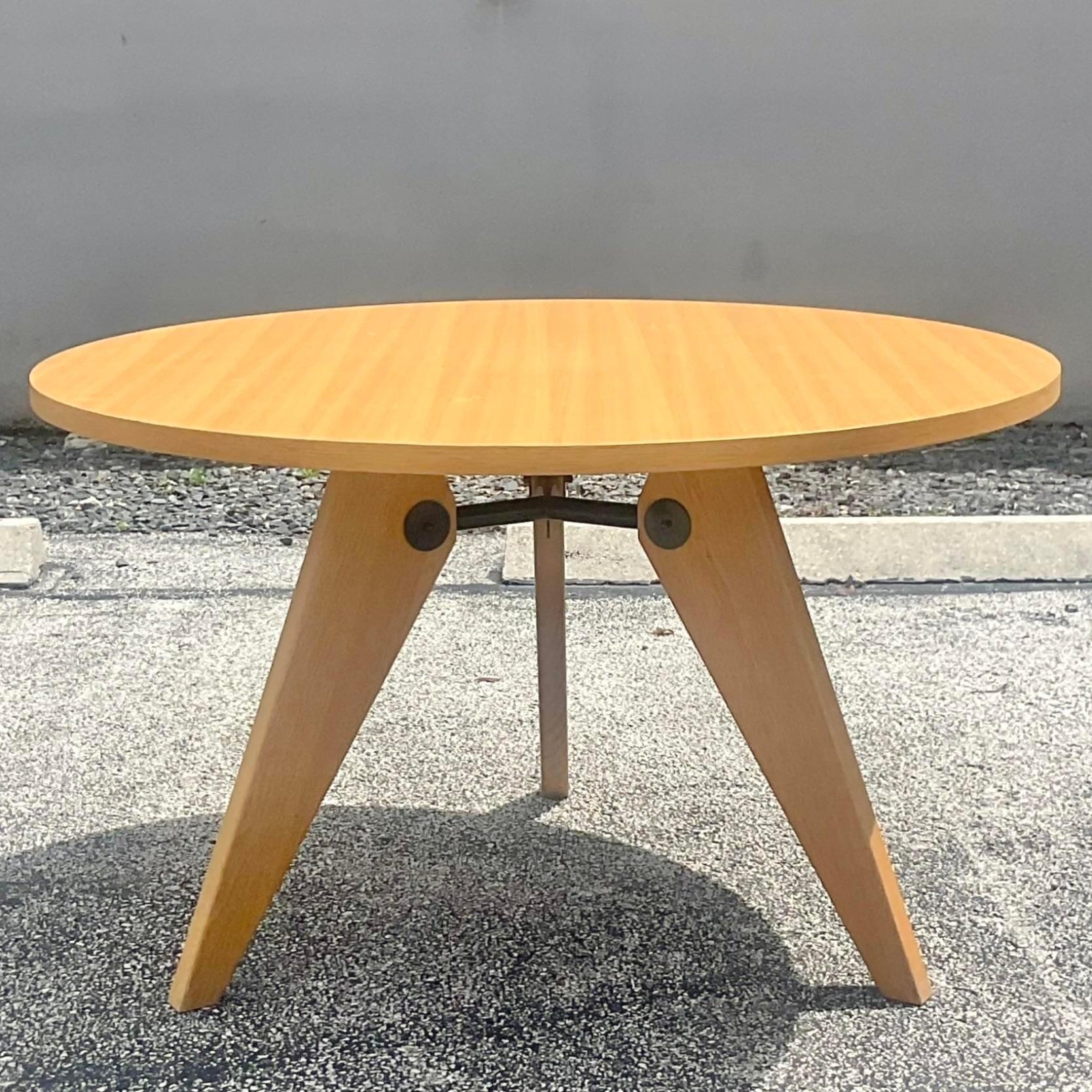 A fabulous vintage Boho dining table. The iconic Gueriodon table designed in the manner of Jean Prouve. Beautiful oak frame with beautiful wood grain detail. Acquired from a Palm Beach estate.