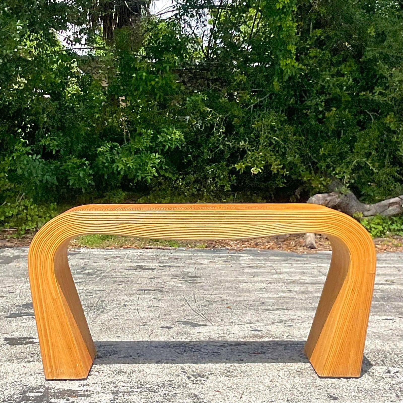 A fabulous vintage Boho waterfall console table. Beautiful pencil reed construction with the coveted rising sun design. Acquired from a Palm Beach estate.