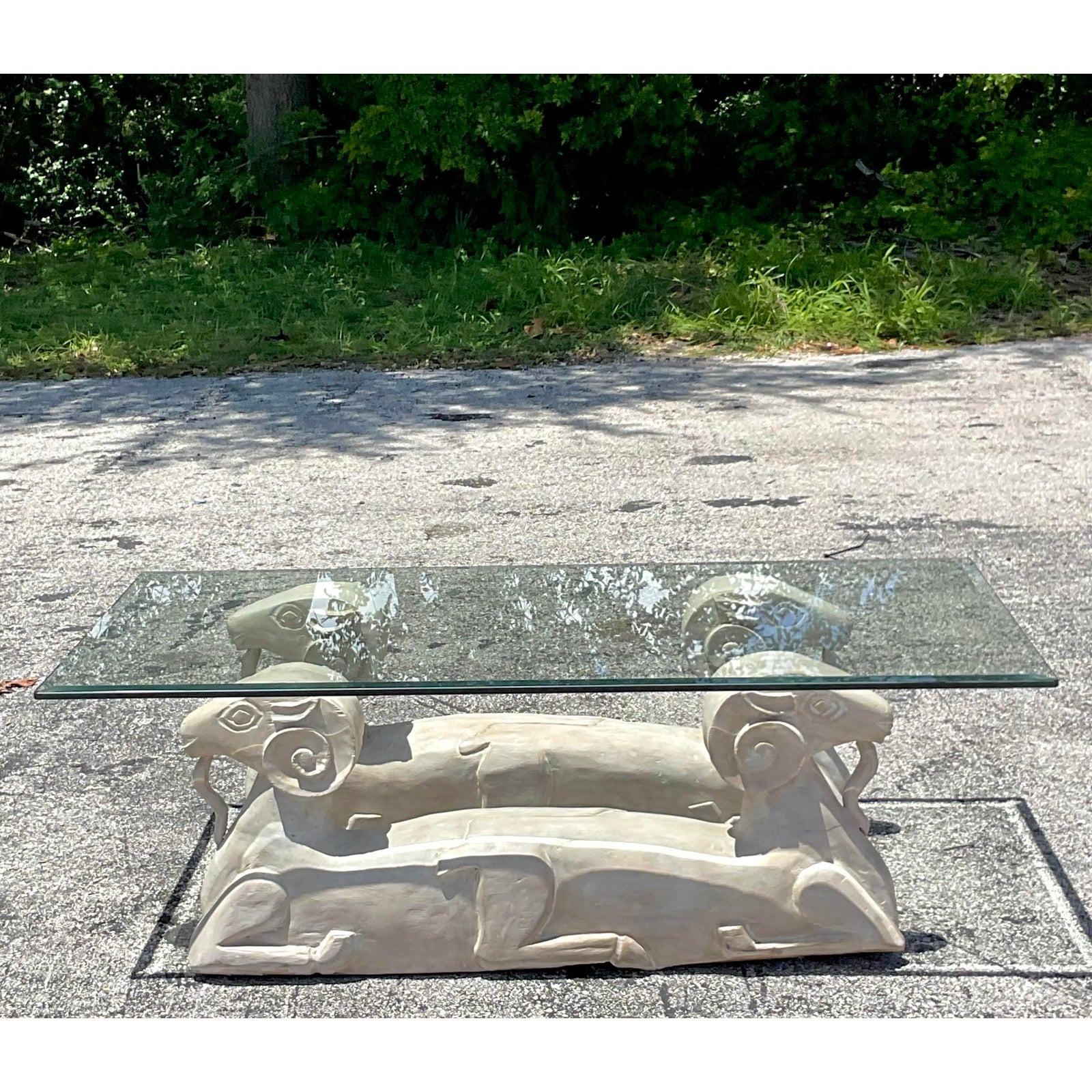 A fabulous vintage Boho coffee table. A chic pair of plaster over wood ram’s head design. Heavy glass top. Acquired from a Palm Beach estate.