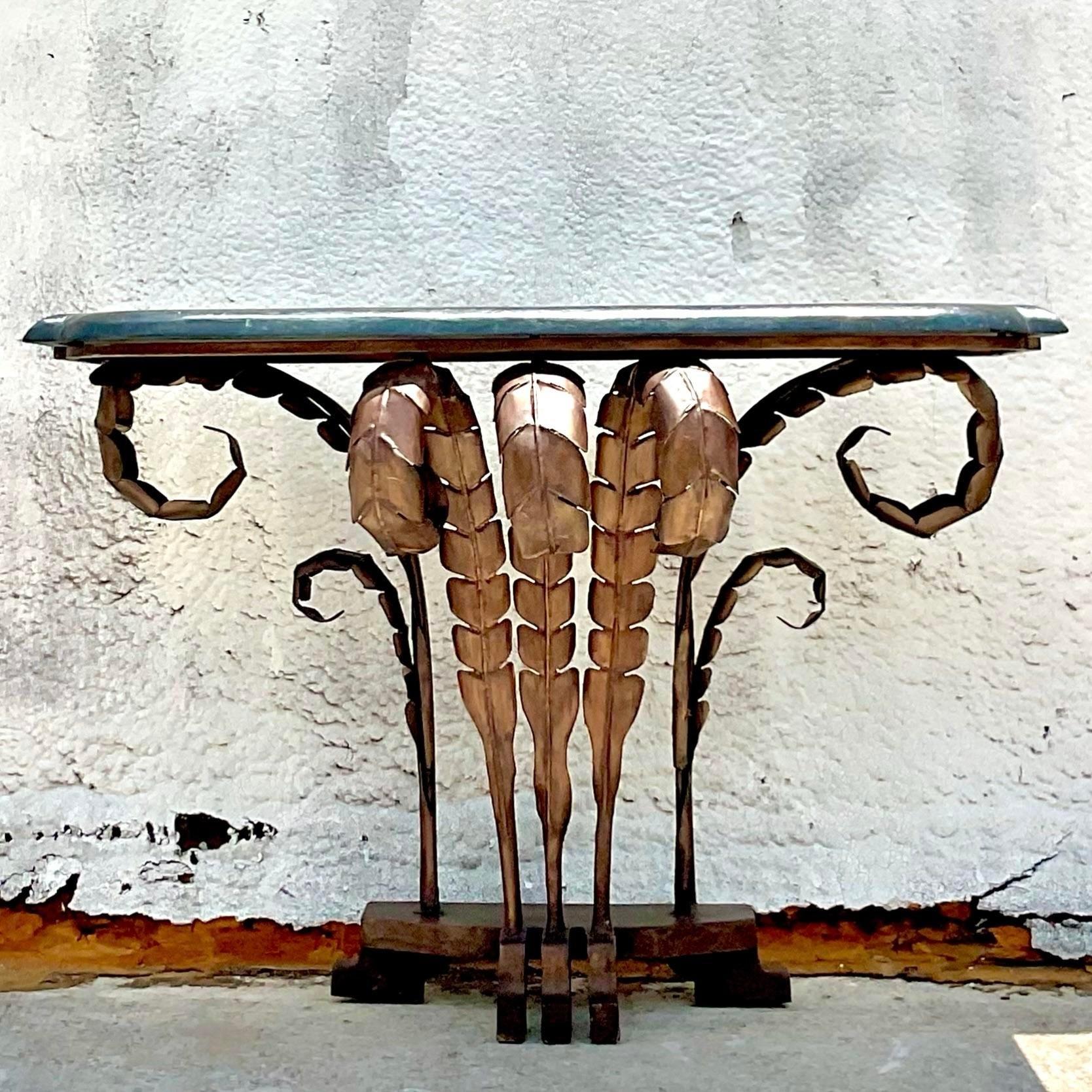 Introduce a touch of bohemian flair to your home with the Vintage Boho Punch Cut Frond Console Table. Crafted in the USA, this unique piece features intricate punch-cut frond detailing, blending effortless boho style with classic American
