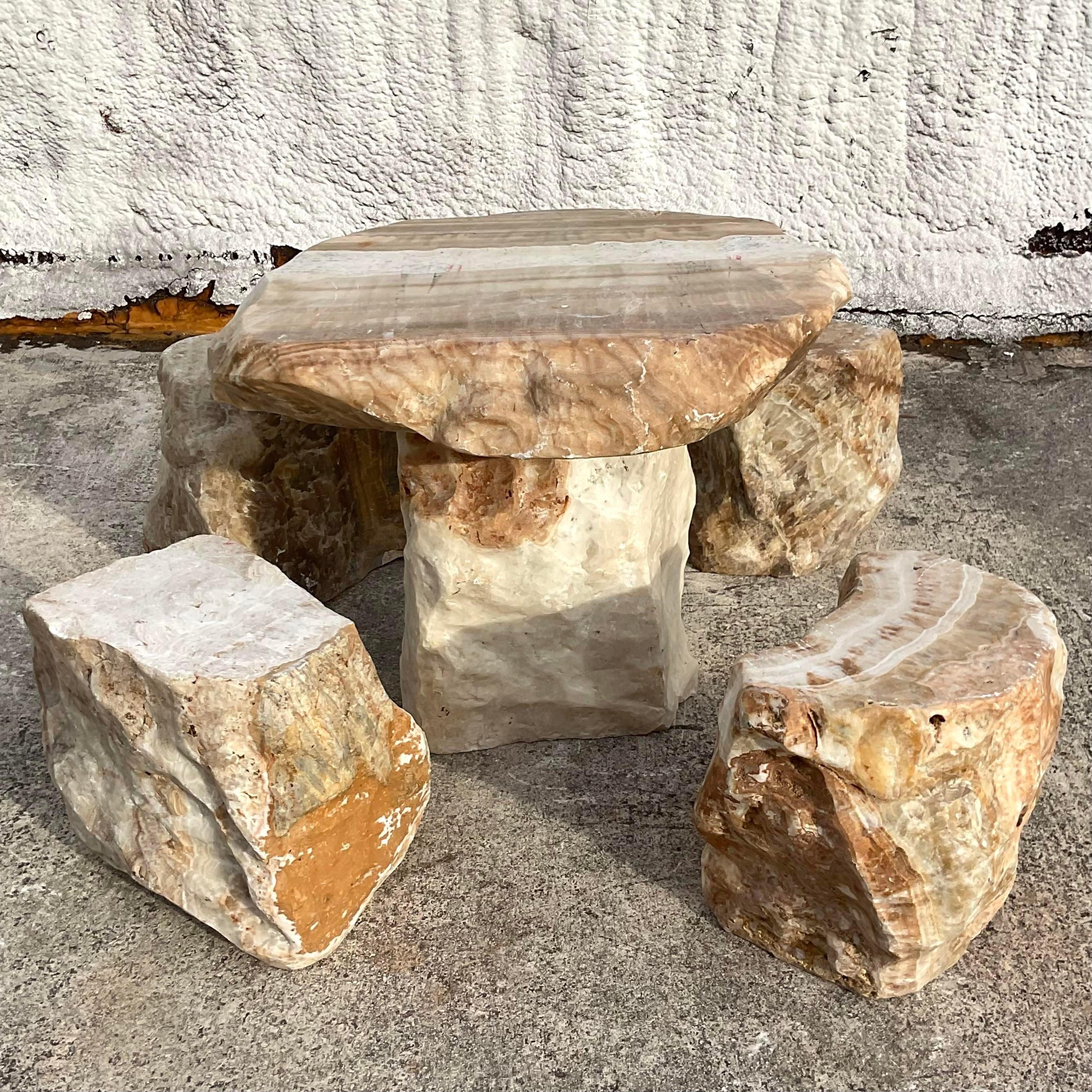 A fabulous vintage Boho dining set. A petite table and block chairs in solid slab stone. Beautiful grain detail. Acquired from a Palm Beach estate.

Seat height 14x11.5x15