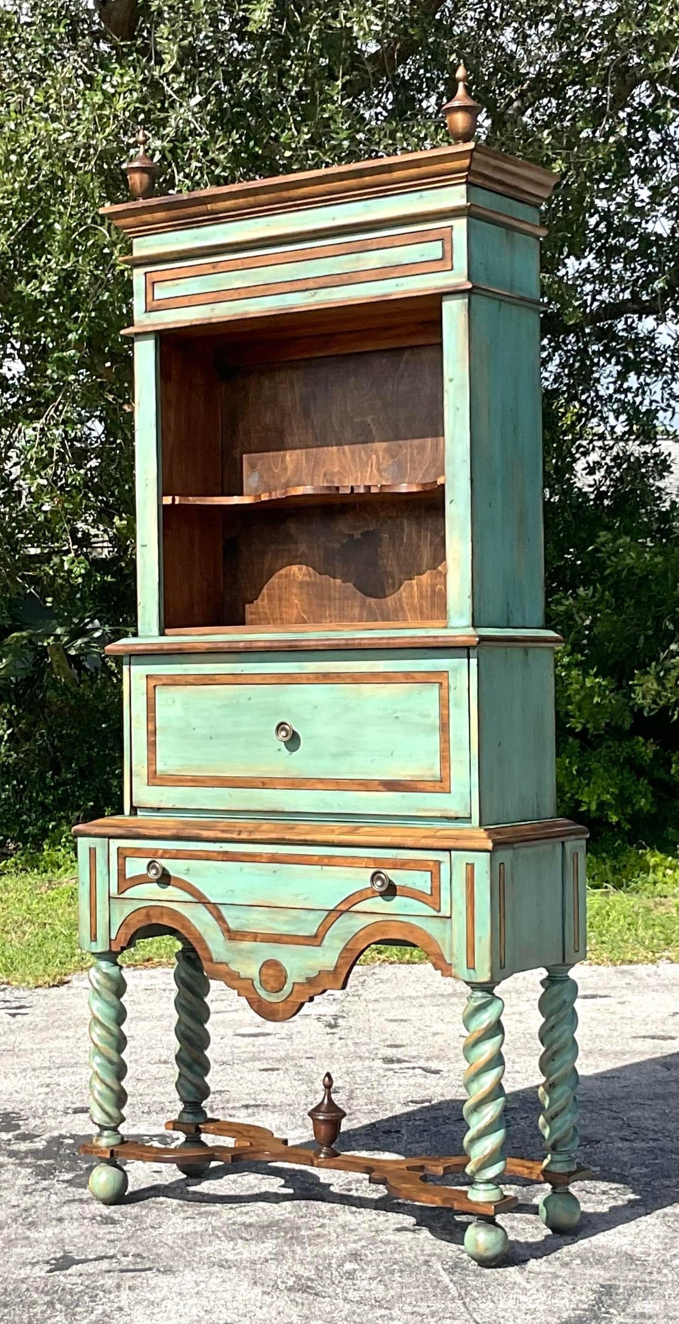 An exceptional vintage Boho display cabinet. Monumental in size and drama. A chic Barley Twist leg with a series of stacked cabinets. Brilliant jade green finish. Acquired from a Palm Beach estate. 