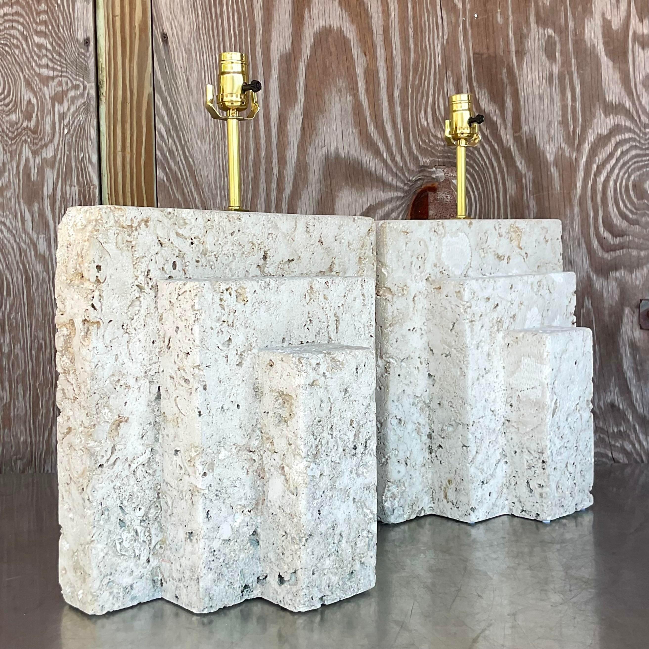 An exceptional pair of vintage Coastal Stone lamps. Gorgeous stacked Coquina stone with brass hardware. Fully restored with all new hardware and wiring. Acquired from a Palm Beach estate.