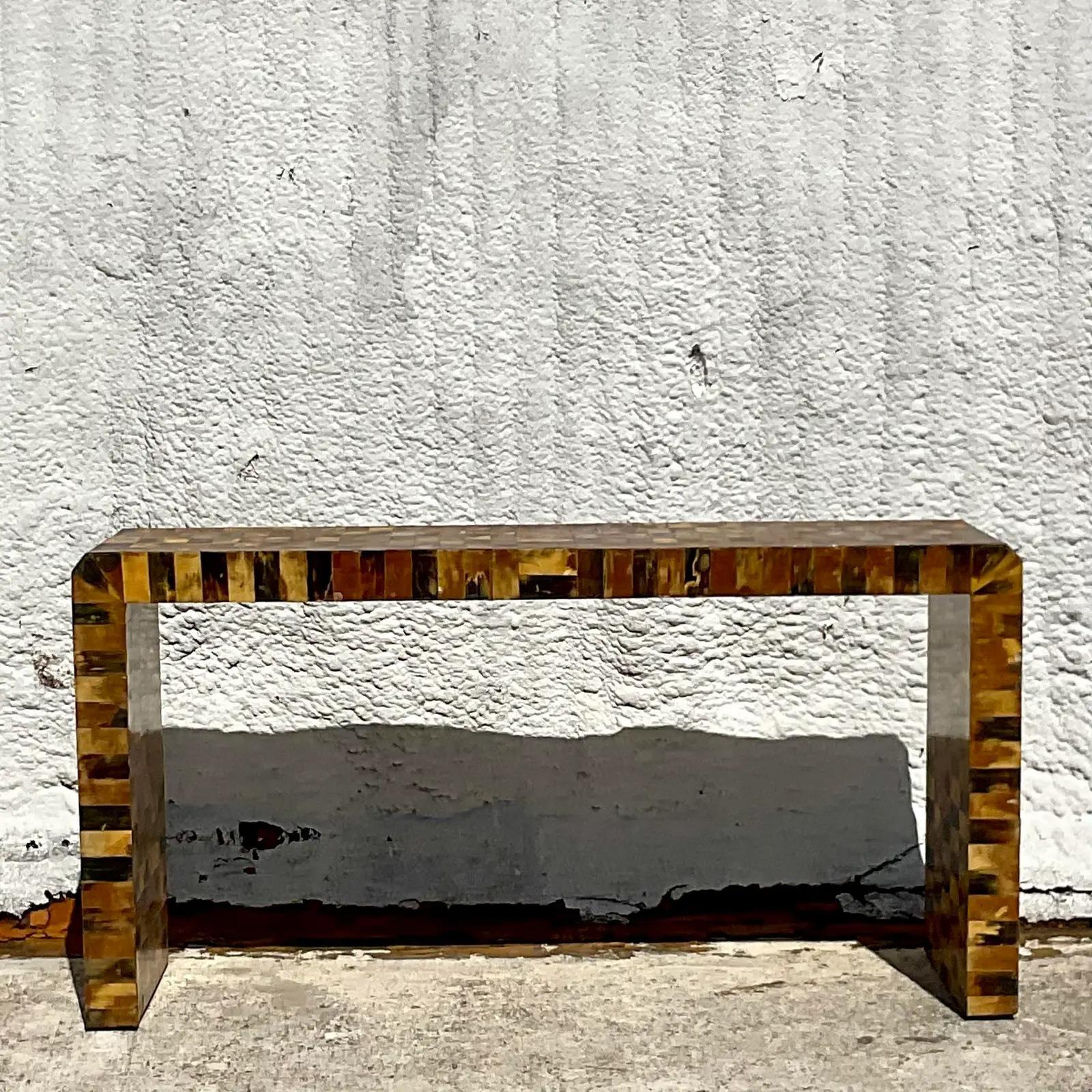 An exceptional vintage Boho console table. A chic tessellated horn with a warm patina from time. A a clean and simple design with a luxurious material. Acquired from a Palm Beach estate.

The table is in good vintage condition. Scuffs and